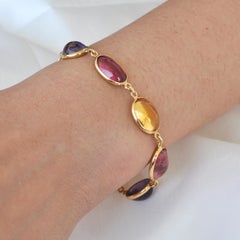 Bracciale in oro 18 carati con gemme ovali cabochon di tormalina, iolite e citrino