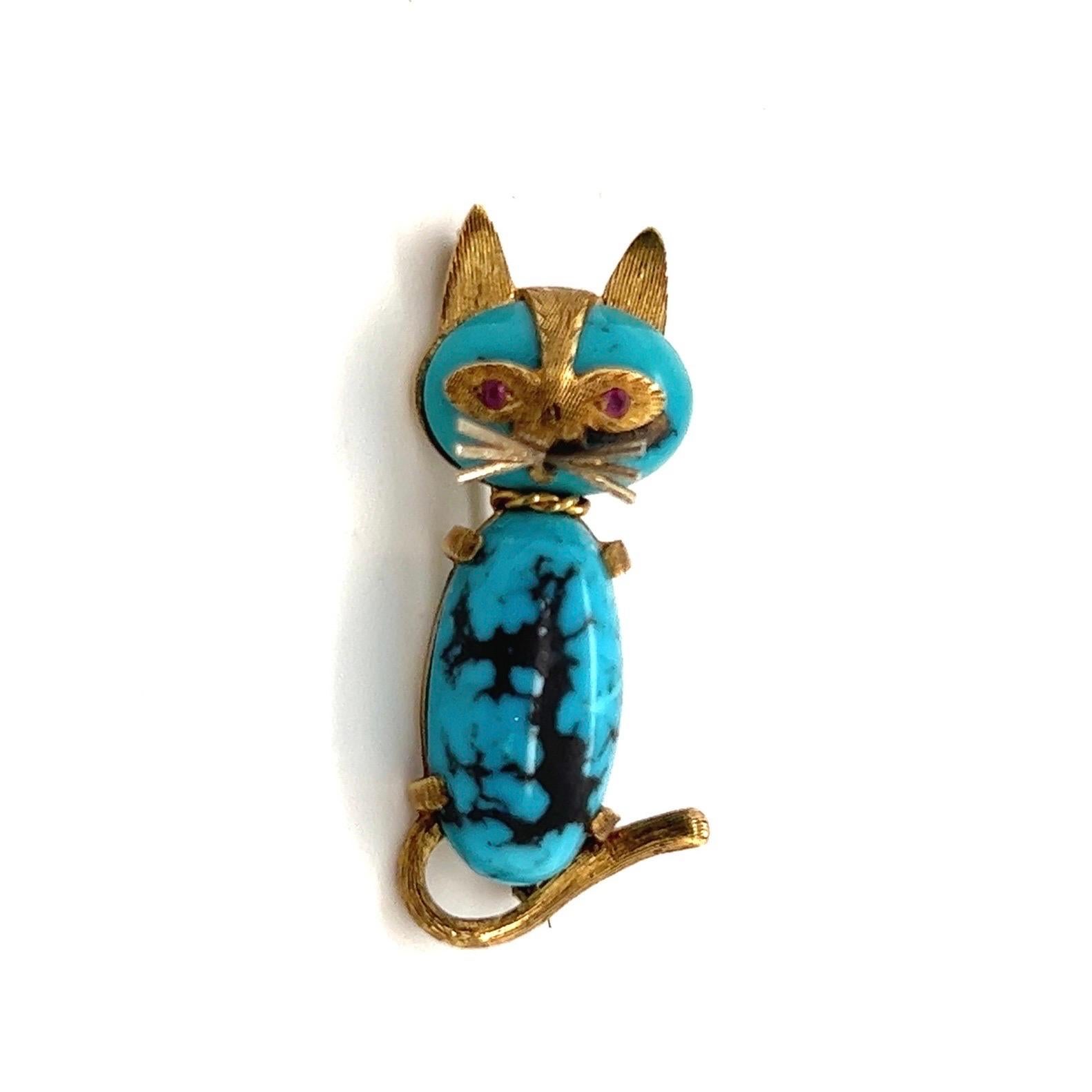 Absolutely adorable 18 karat gold, turquoise and ruby cat pin brooch by the house of Cartier, circa 1960s.

Crafted in 18 karat satin finish yellow gold, depicting a whimsical cat whose head and body consist in two turquoise cabochons. The eyes are