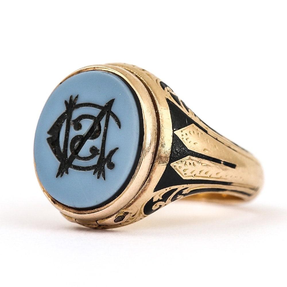 A superb mourning signet ring, chalcedony seal set with a monogram of the letters CSN, the hinged top opens to reveal a locket compartment with a small oval portrait photograph. The reverse is engraved 'William Nelson Died Jan 11th 1866', mounted in