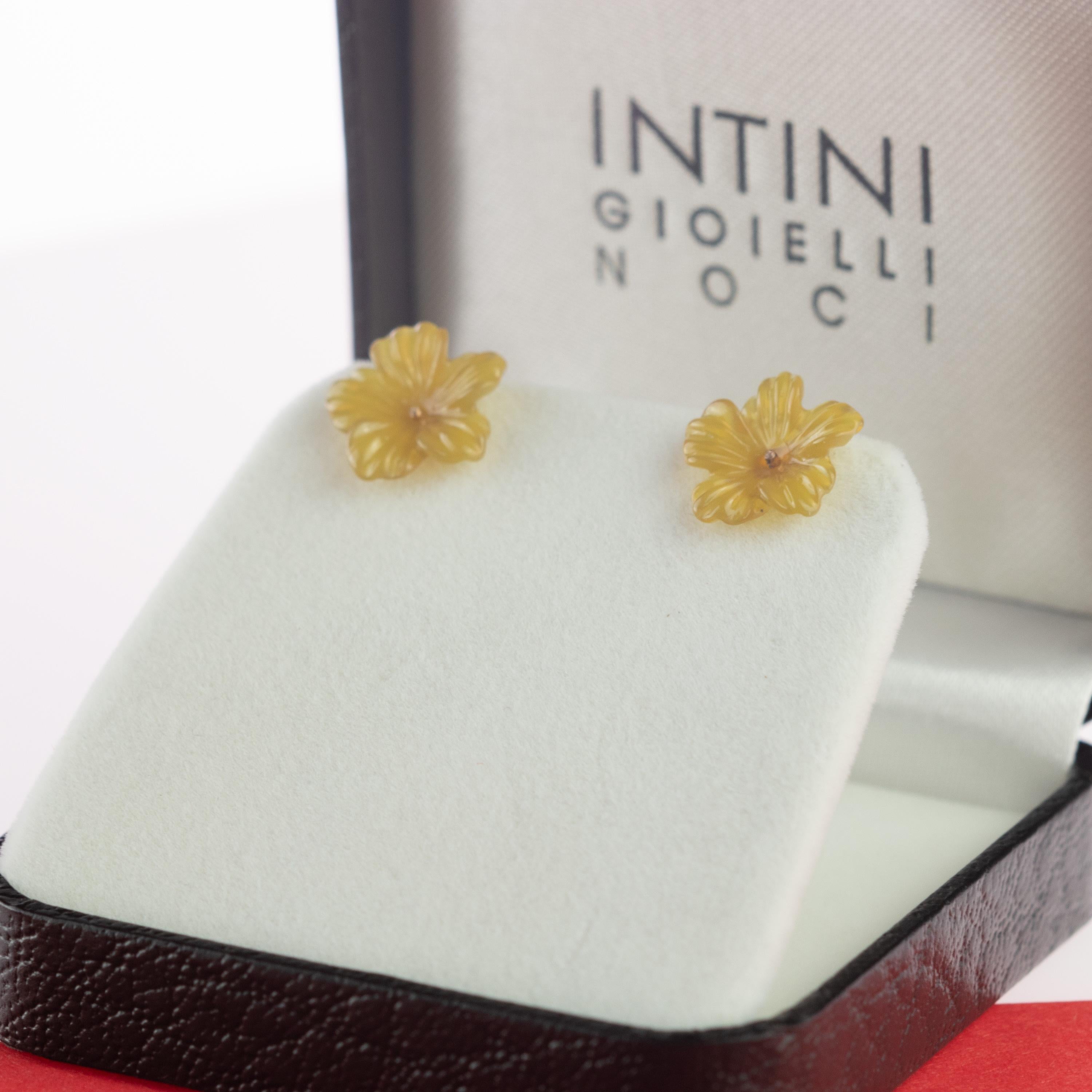 Delicate natural 5 carat yellow agate flower earrings with a marvelous transparent color. Carved petals that evoke the italian handmade traditional jewelry work embellished with 18 karat yellow gold.

The color yellow is primarily associated with