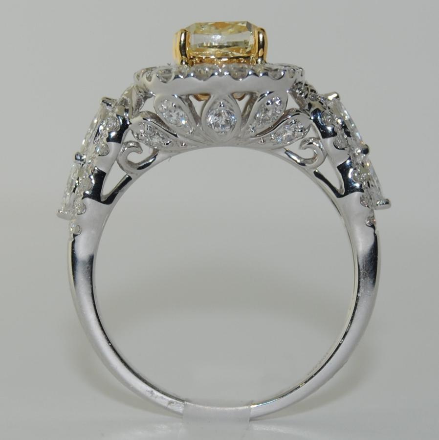 This ring features Cushion Center Fancy Diamond/Yellow, with Marquise and Round White Diamonds total weight 2.74 Carats, made in 18 Karat White Gold, Size 6.5