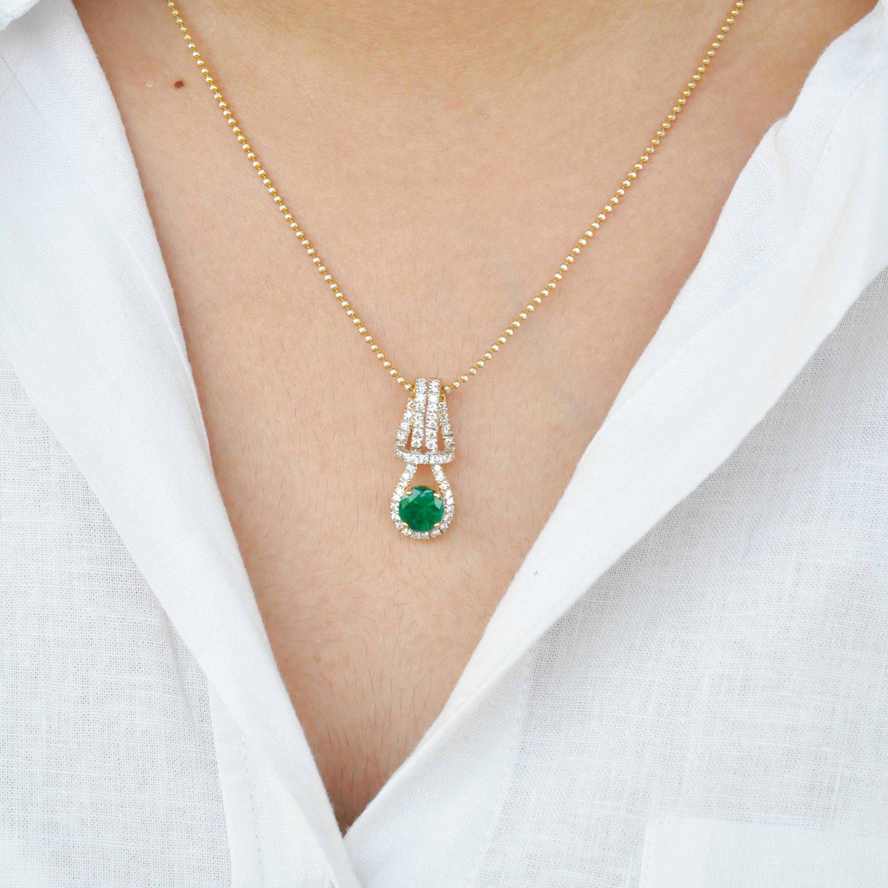 18 karat yellow gold natural zambian emerald round diamond pendant necklace.

Very good quality round zambian emerald is used in the pendant necklace along with diamonds. The pendant necklace is set in 18 karat Gold. The diamonds used are of