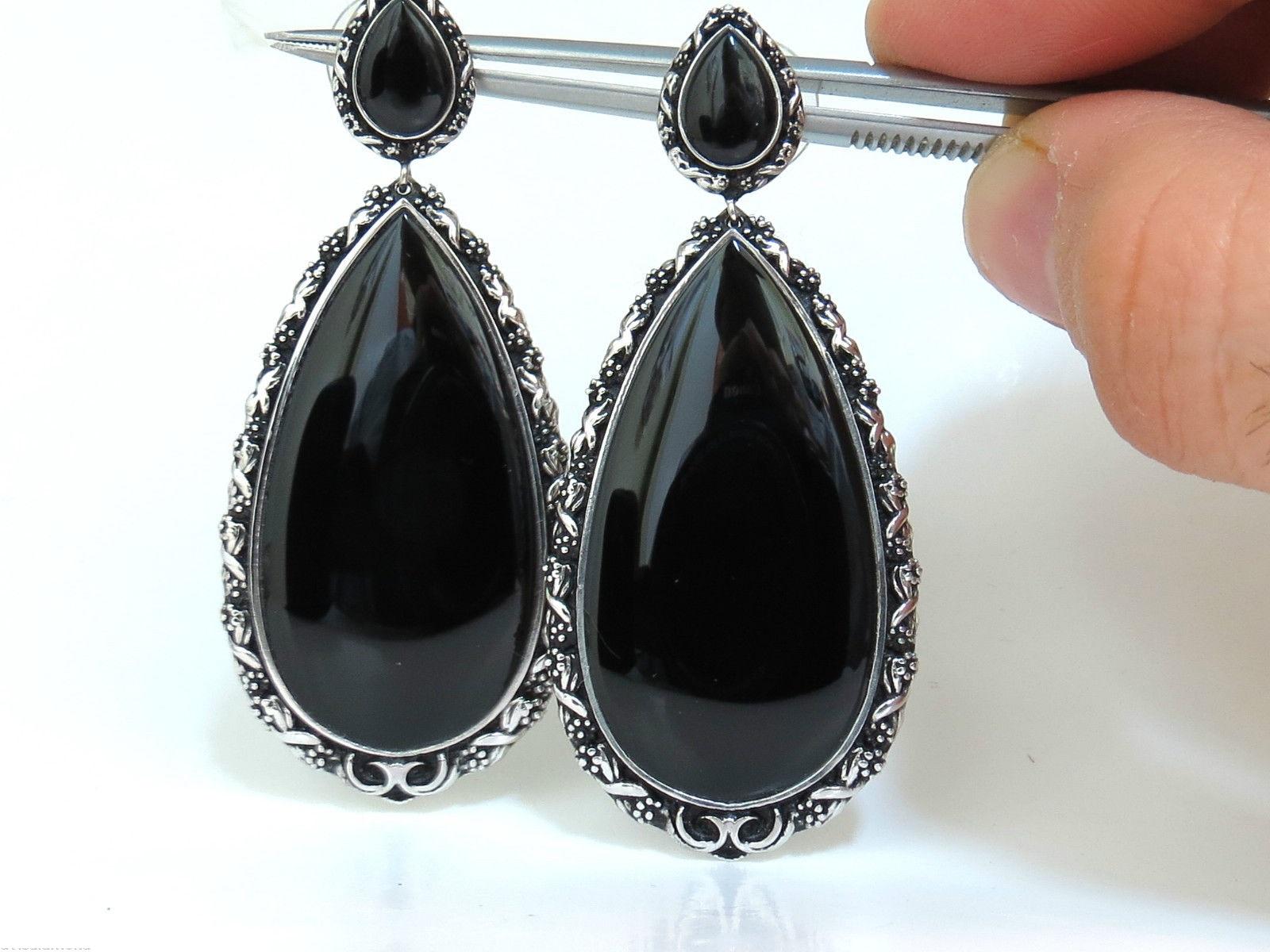 Victorian Inspired 

Gothic Jet Black Natural Onyx 

3D Raised Gilt deco 

18Kt. White gold.

32 Grams.

2.48 Inch long 

1.09 inch wide at lower dangle.

$5500 Appraisal will accompany