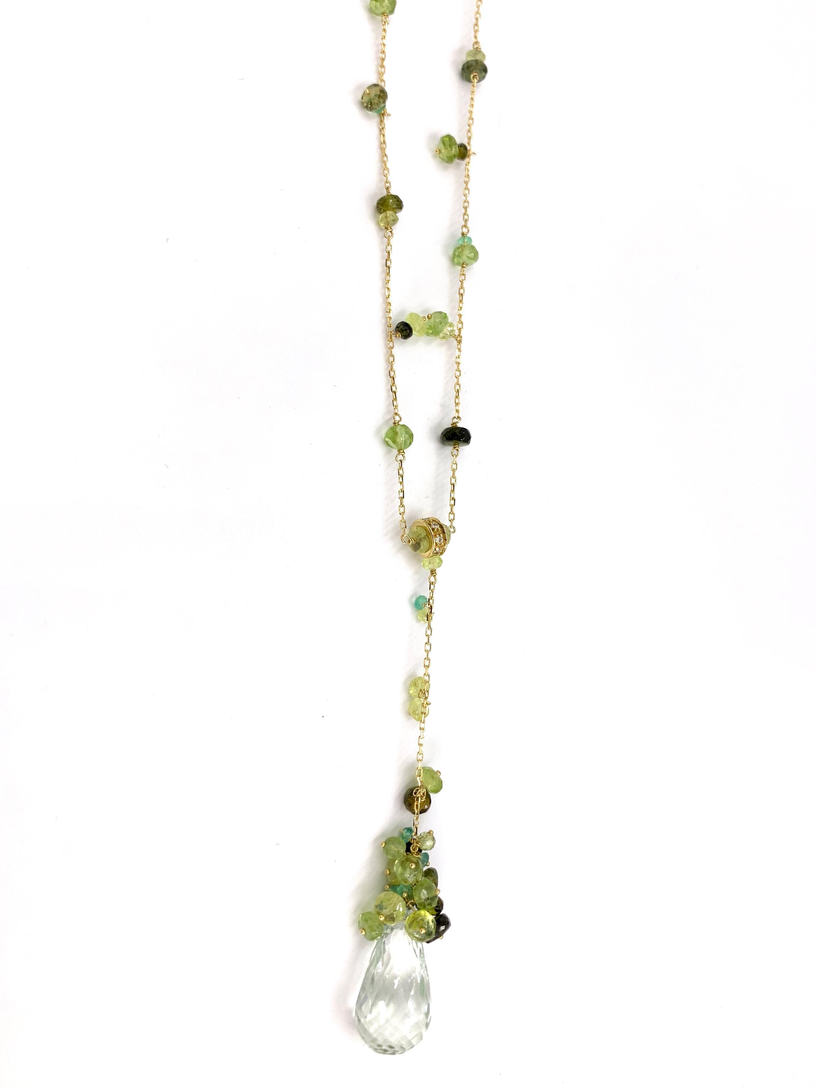 Created by high jewelry Italian designer, Mariani. This 18 karat yellow gold lariat style necklace features a beautifully faceted 14 carat green amethyst gemstone that dangles from the cable chain featuring emeralds and green tourmaline arranged in
