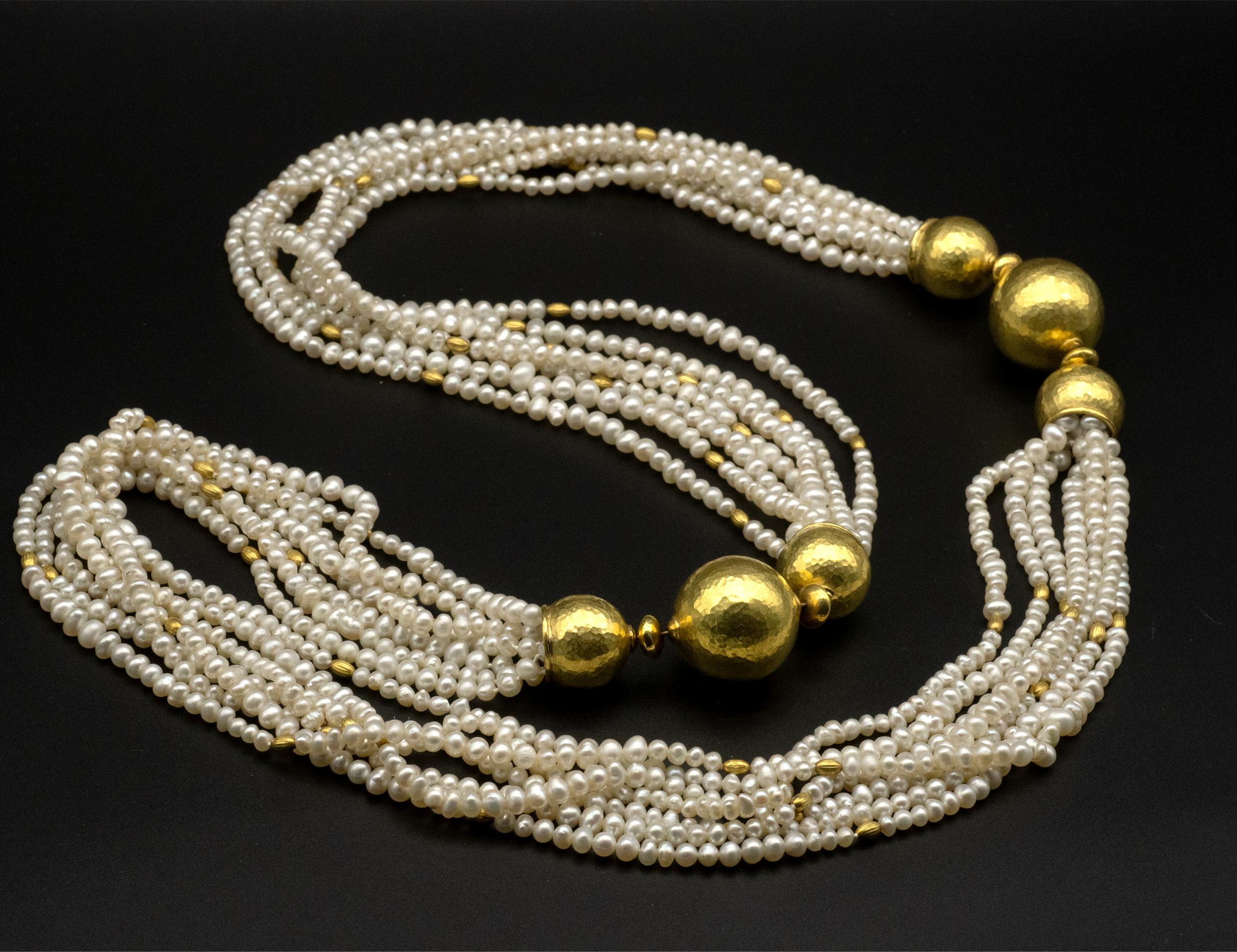 Stunning multi-strand pearl necklace with important hand hammered 18 Karat gold balls. The pearl strands are highlighted with smaller rice shape gold inserts. The earrings are1 8 Karat Hammered Gold perfectly round domes . Their beauty comes from