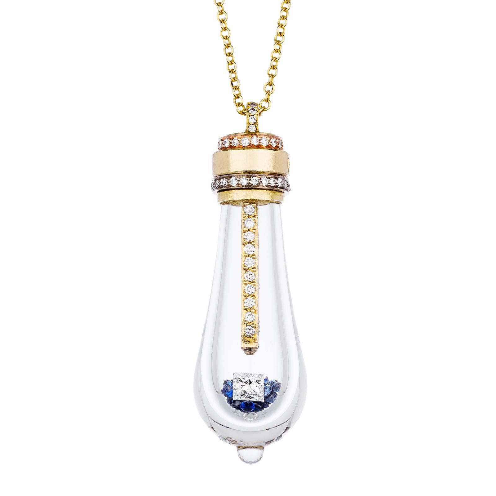18k Lightkeeper Necklace features a large hand blown glass bulb with white diamond pave in the center filament, white diamond pave halo around the two tone yellow and rose gold top, filled with 50 blue sapphires, 1 princess cut white diamond, set in