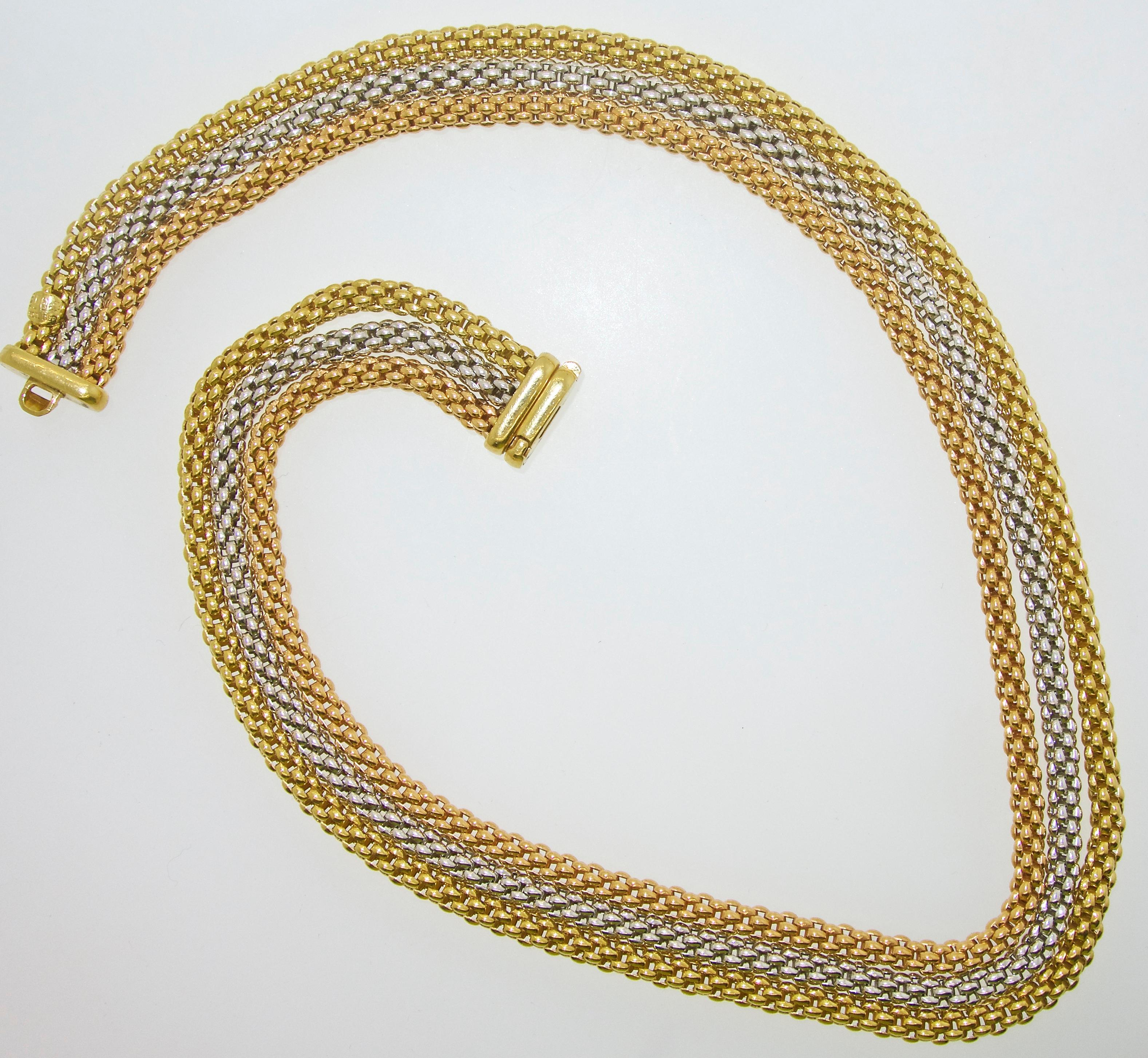 18K gold necklace with three different colors of gold.  The unusual hand made link of three strands nests perfectly on the neck.  17 inches long and weighing 69.92 grams.  Fope is a fine Italian designer known world wide for their innovative