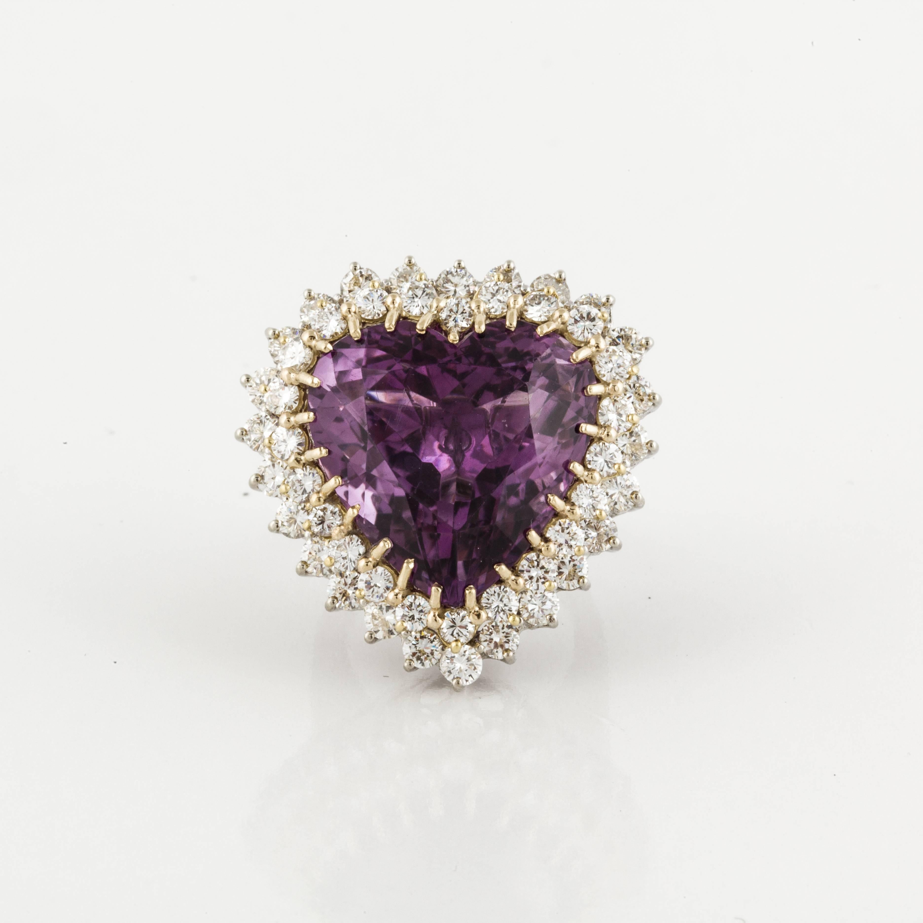 Ringdant which can be worn as a ring or pendant, is composed of 14K gold featuring a heart-shaped amethyst that totals 27 carats.  The amethyst is framed by a double row of 47 round diamonds that total 4.50 carats; G-I color and VS1-VS2 clarity. 