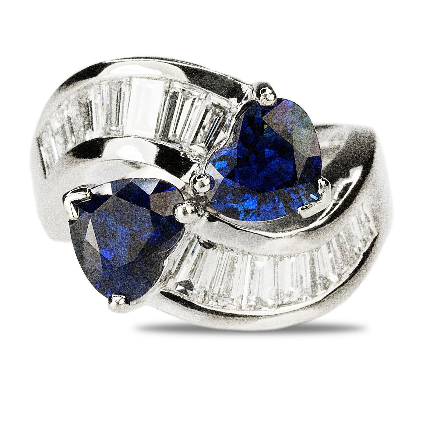 18k White gold ring with two top gem quality heart shaped sapphires weighing 3.36 carats total weight and 14 baguette diamonds weighing 2.38 carats. 13.25 grams This ring was purchased at Mayors Jewelers and was appraised at $26,705.00