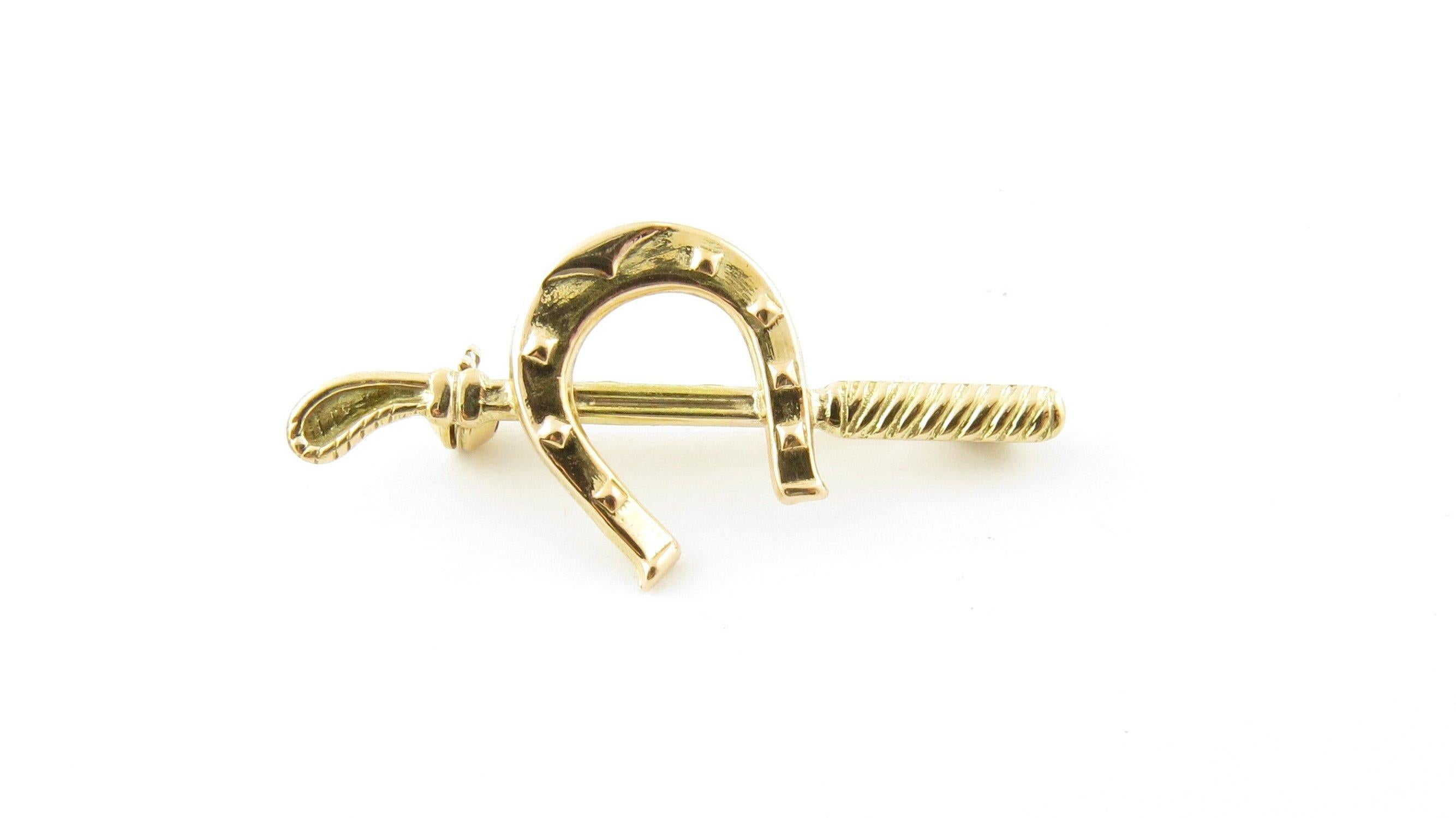 Vintage 18 Karat Yellow Gold Horseshoe and Riding Crop Pin/Brooch- Perfect gift for the equestrian in your life! This lovely brooch features a horseshoe and riding crop meticulously detailed in 18K yellow gold. Size: 39 mm x 18 mm Weight: 1.6 dwt. /