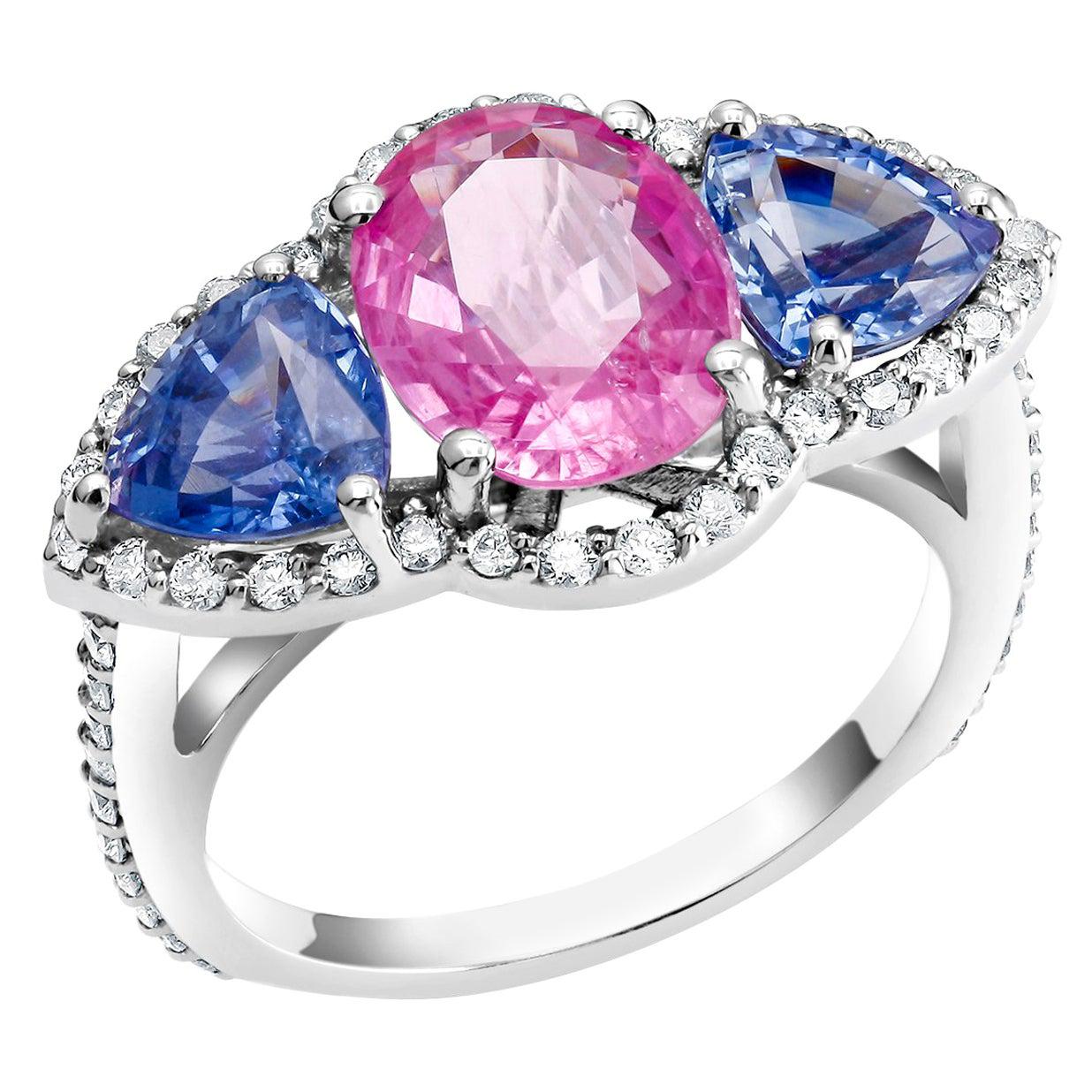 One of a kind eighteen karats white gold cocktail ring
Fucsia Ceylon pink cushion-shaped sapphire weighing 2.98 carats 
Matched pair of trillion Ceylon cornflower blue Sapphire weighing 2.32 
Surrounded by pave set diamonds weighing 0.75 carats 