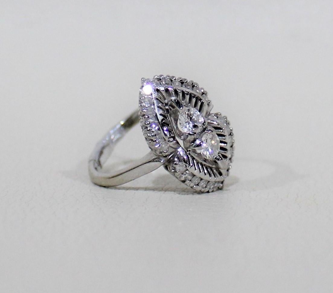 Stamped 18 carat vintage white gold ladies hand assembled custom made ring with a bright polish finish.

Specifications:

Ring size: 5.75
Total weight of diamonds 0.69-carat
Total weight of ring 5.20 grams

Two claw set round brilliant cut