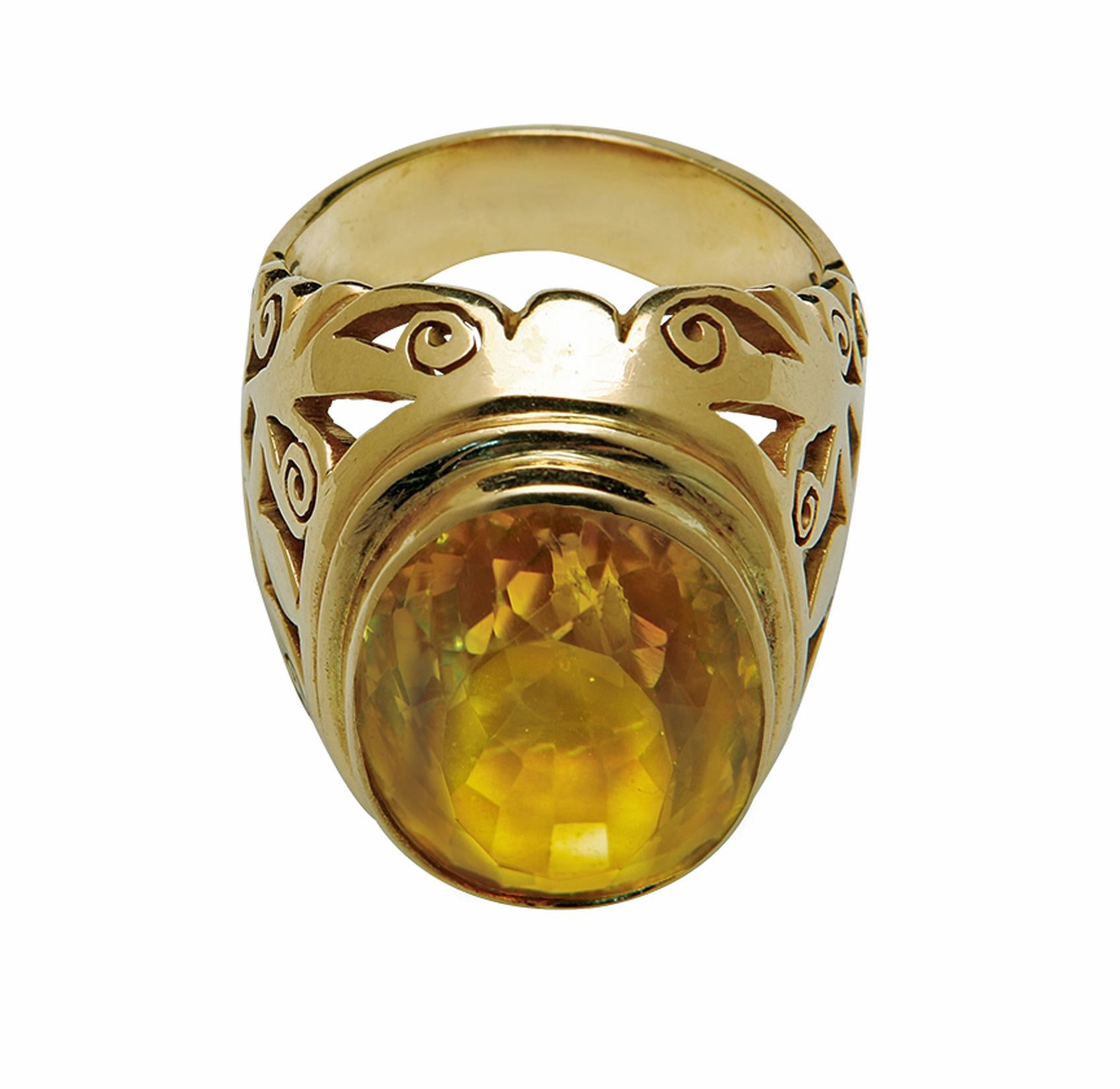 18K rose gold large Citrine Ring, C.1950. The ring of substantial size bezel set with an oval facetted medium yellow citrine, approximately 30.00 cts. The mount of intricately carved Russian like design. Stamped 18 on outside shank. Likely Russian