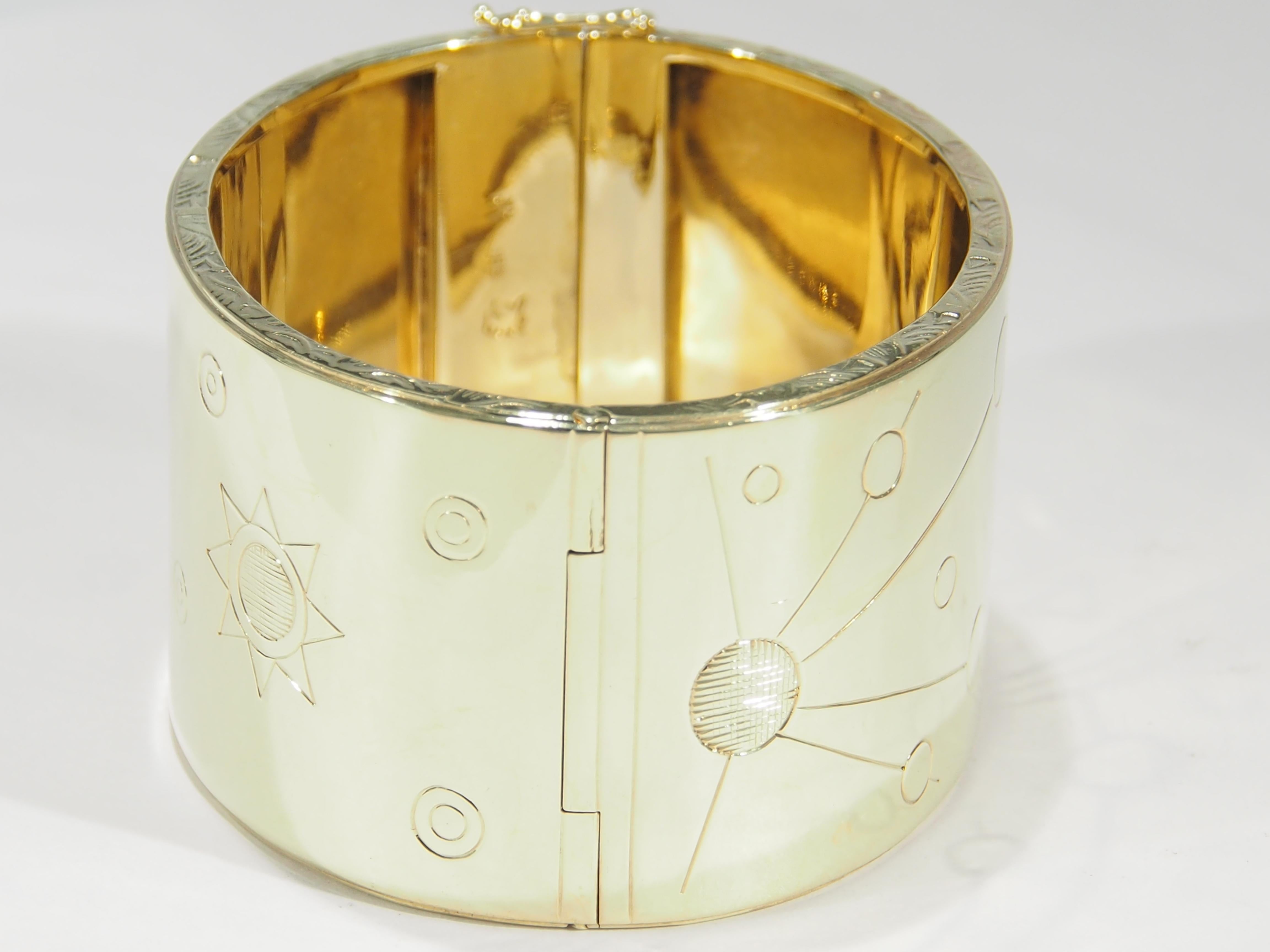 This is a stunning 18K Yellow Gold Wide Cuff Bracelet created with Hand-Made details. The Bracelet has engraved Cosmic Motifs of the Sun and the Planets in a 1 1/2 inch width making this a most fascinating Cuff. Please see the photographs to fully