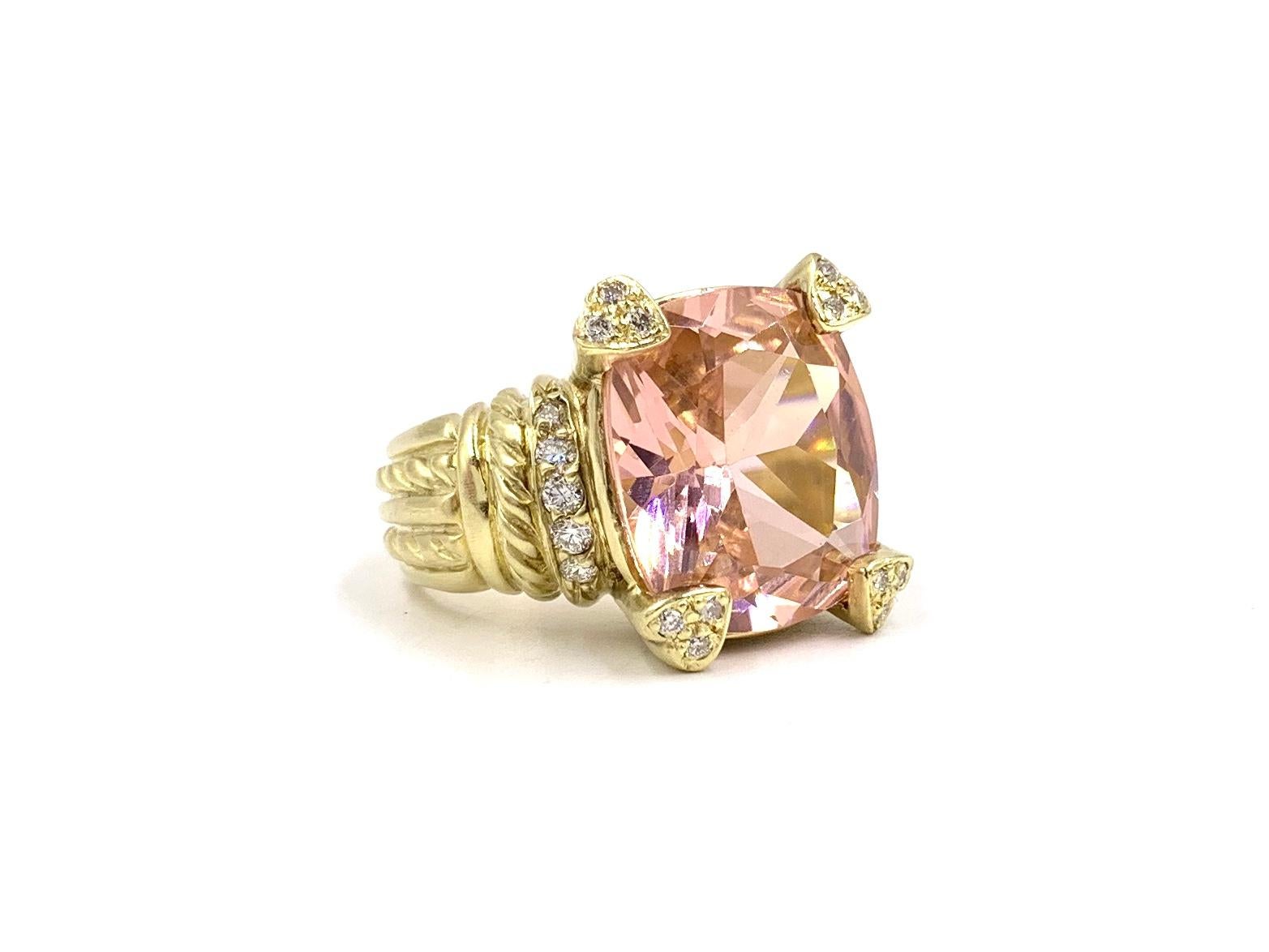 A solid and substantial 18 karat yellow gold cocktail ring by Judith Ripka featuring a large vibrant and lively cushion cut pink quartz with diamond encrusted heart shape prongs and ribbing. Diamond total weight is .30 carats at approximately F-G