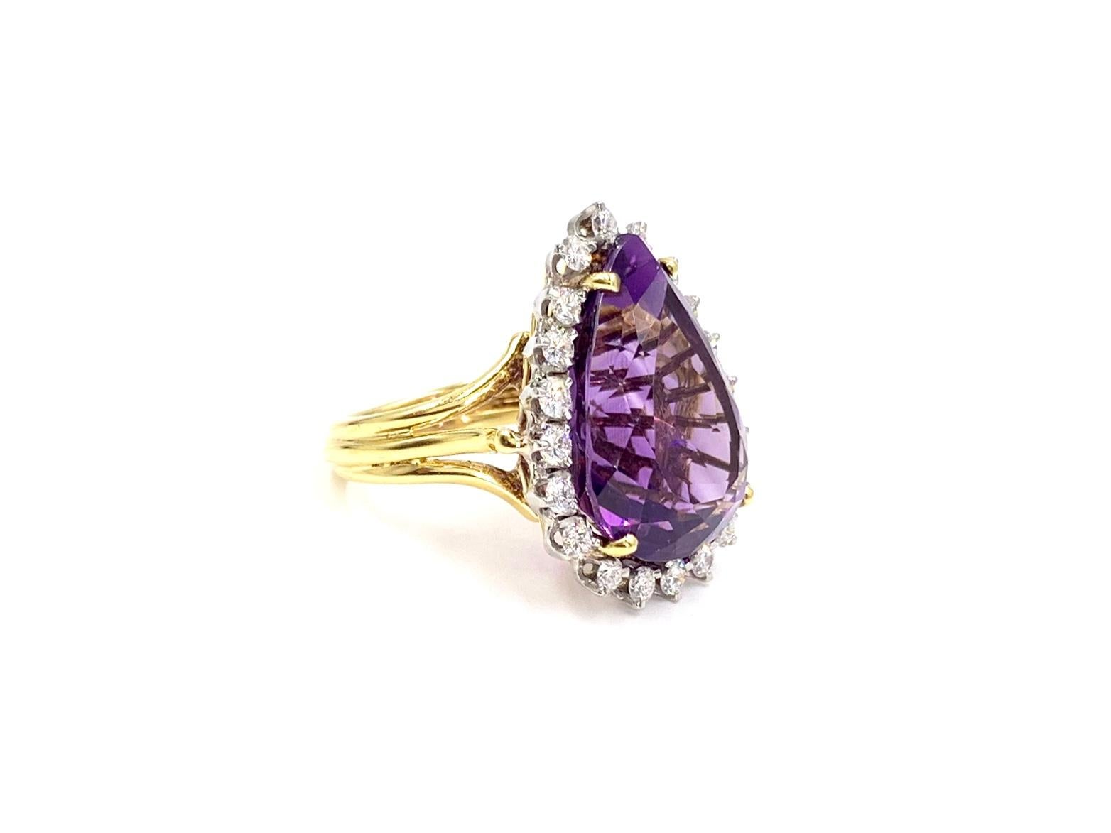 An absolute stunner. This 18 karat two tone cocktail ring features a gorgeous, well saturated faceted pear shape amethyst weighing approximately 17 carats surrounded by 20 round brilliant white diamonds at approximately 1.25 carats total weight.