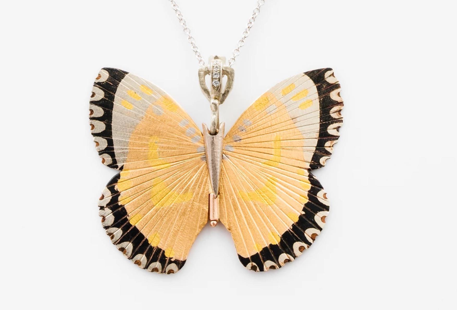James Banks's signature butterfly necklace features a Large White Lacewing species Butterfly with a hinge at the center to allow movement of the wings, made of Shakudo, Platinum, 18k White Gold, 18k Rose Gold, and 24k Yellow Gold, with white diamond