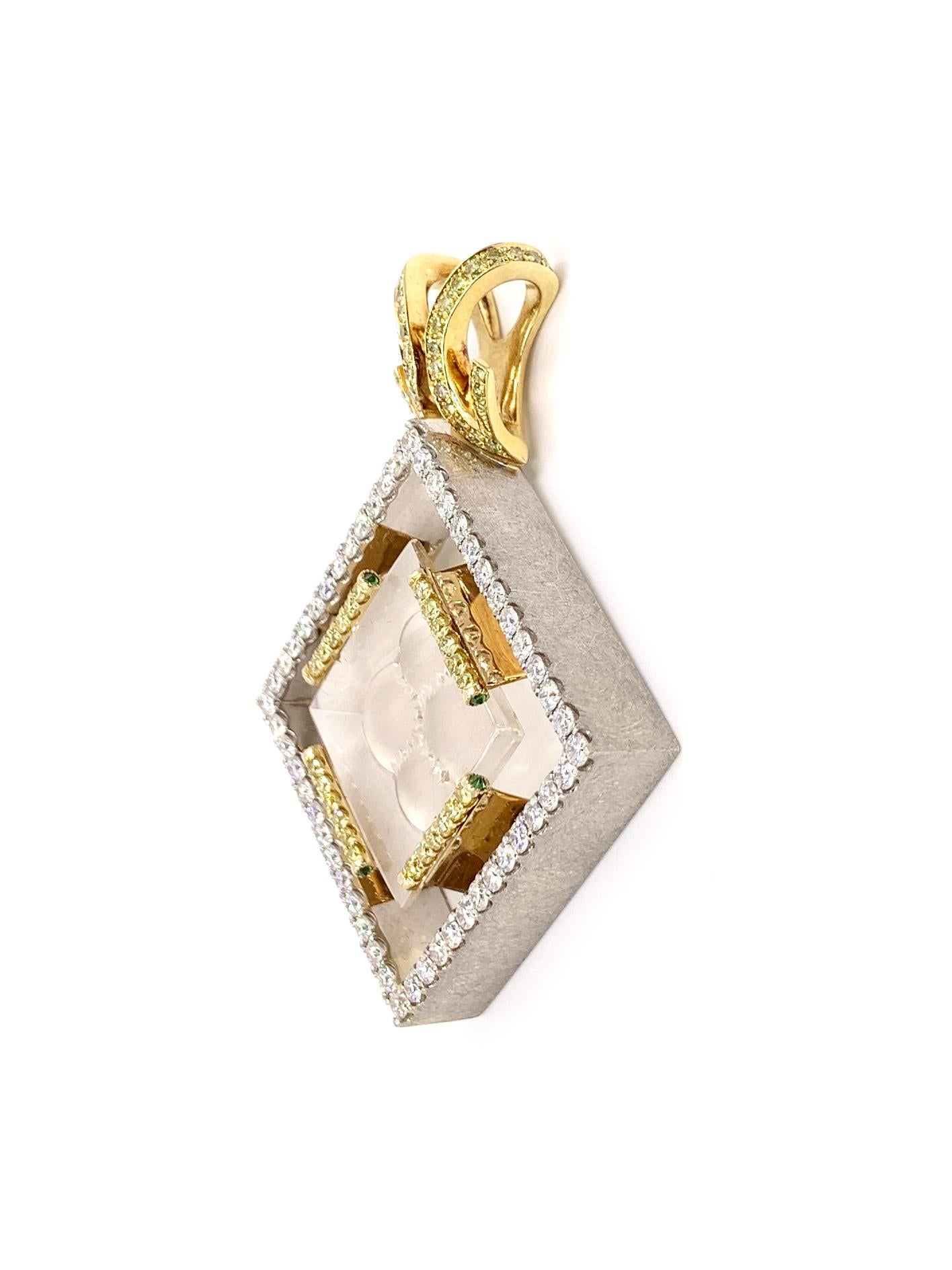 A one of a kind substantial 18 karat white and yellow gold modern pendant featuring a carved rutilated clear quartz with approximately 1.25 carats of white diamonds and .70 carats of yellow diamonds. White diamond quality is approximately F-G color,