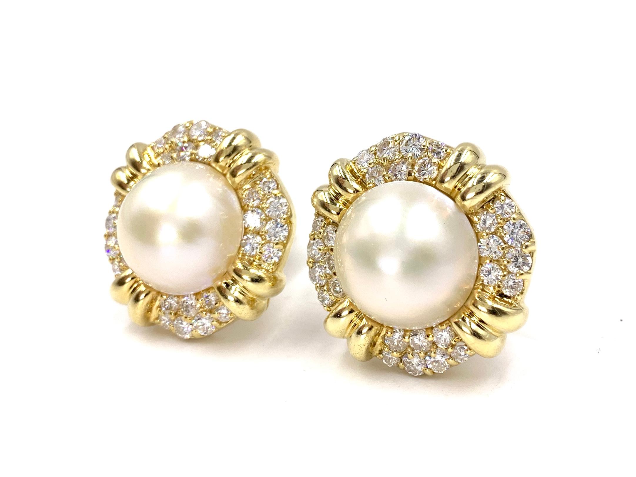Very well made, substantial 18 karat yellow gold button clip-on earrings featuring 17mm smooth mabe pearls surrounded by approximately 3.25 carats of high quality round brilliant white diamonds. Diamonds are approximately F-G color, VS2 clarity.