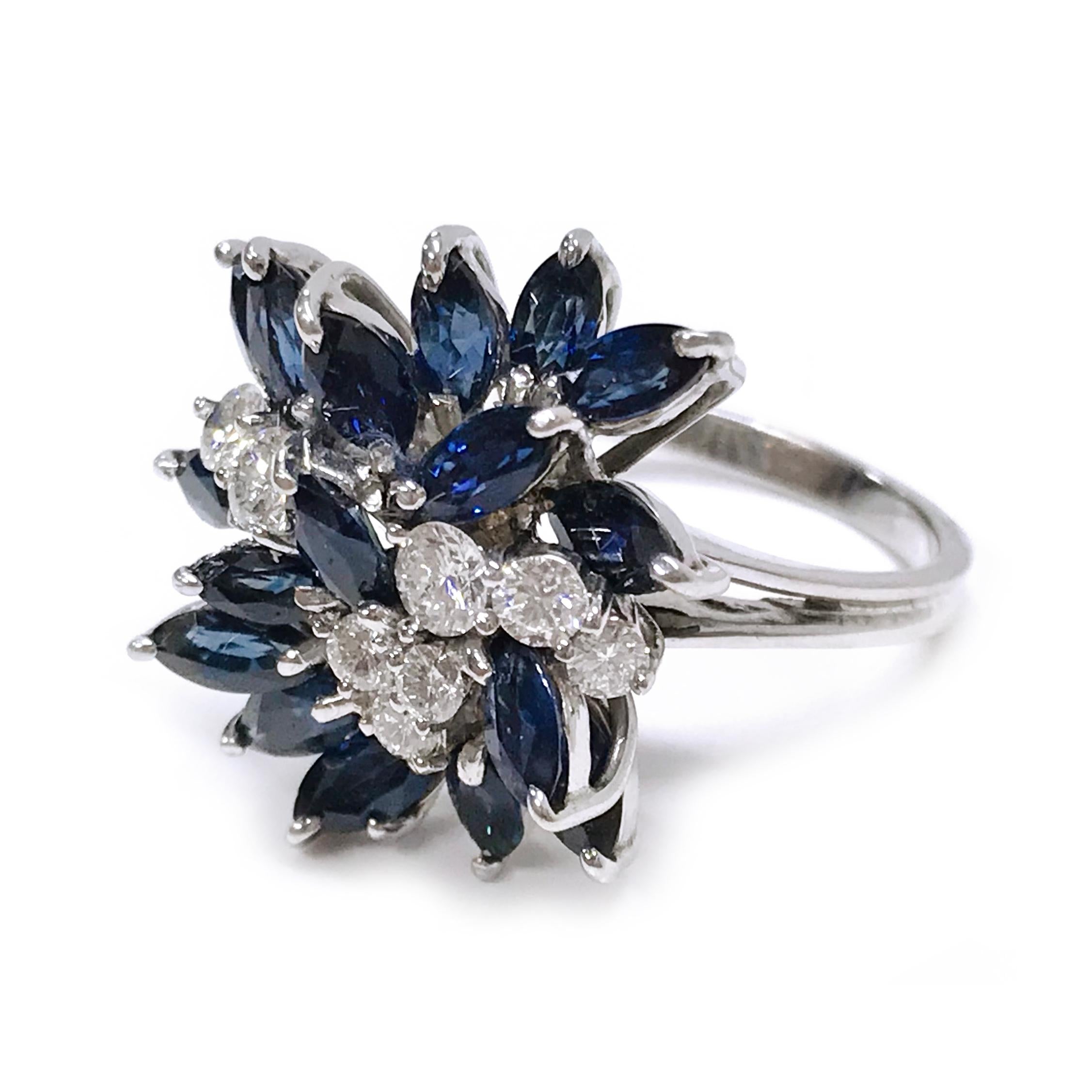 18 Karat White Gold Marquise-Cut Blue Sapphire Diamond Ring. The split ring cluster ring features seventeen marquise-cut blue sapphires and eight round diamonds, all stones are prong-set in white gold. The total carat weight of the sapphires is