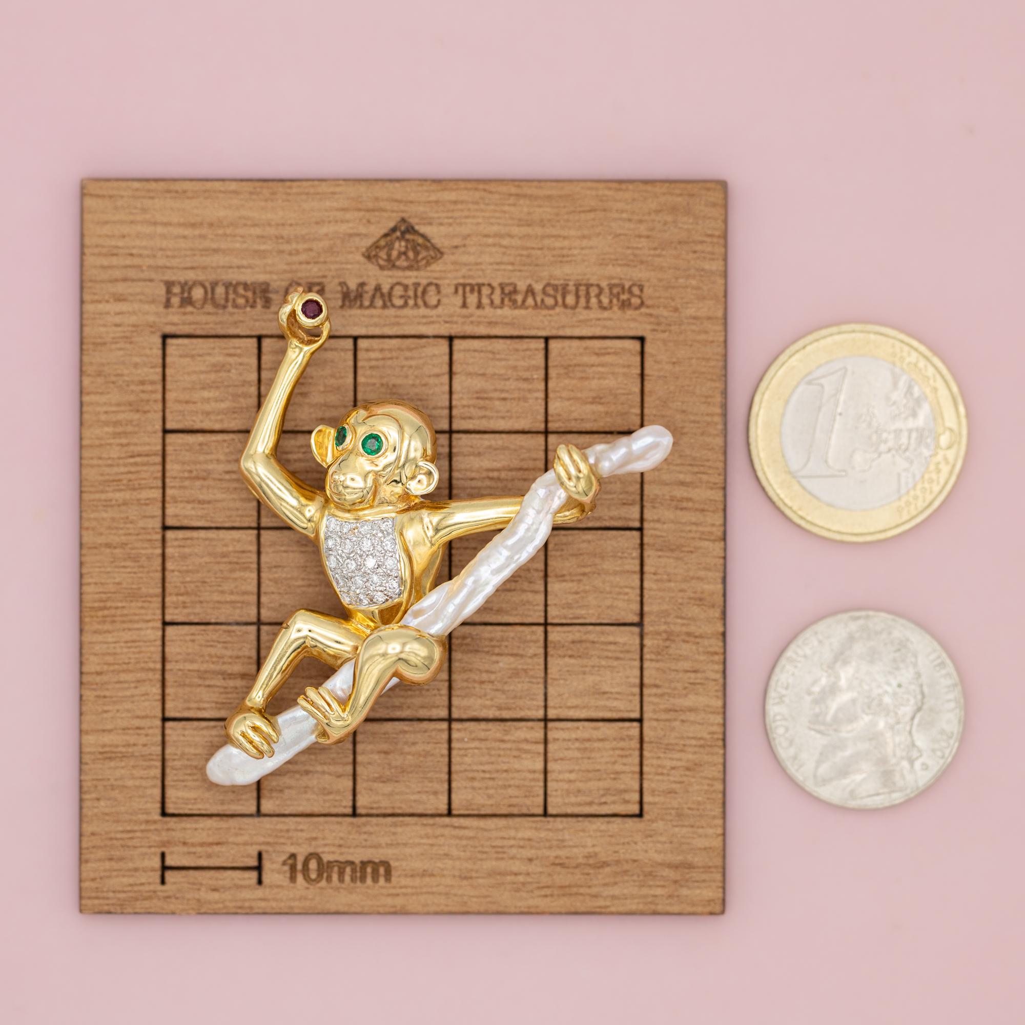 For sale is this incredible monkey brooch. This 18 karat solid yellow gold animal is set with two green emeralds as eyes and nineteen brilliant cut diamonds cover the belly of this joyful animal. He is swinging on a natural white pearl while showing