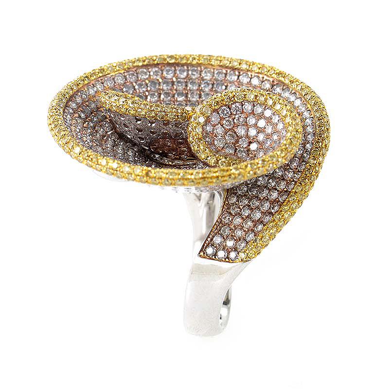 This cocktail ring is unique and shimmers with diamonds. It is made of primarily 18K white gold accented with yellow gold. Each shade of gold is set with diamonds in the corresponding color, totaling at ~6.29ct.