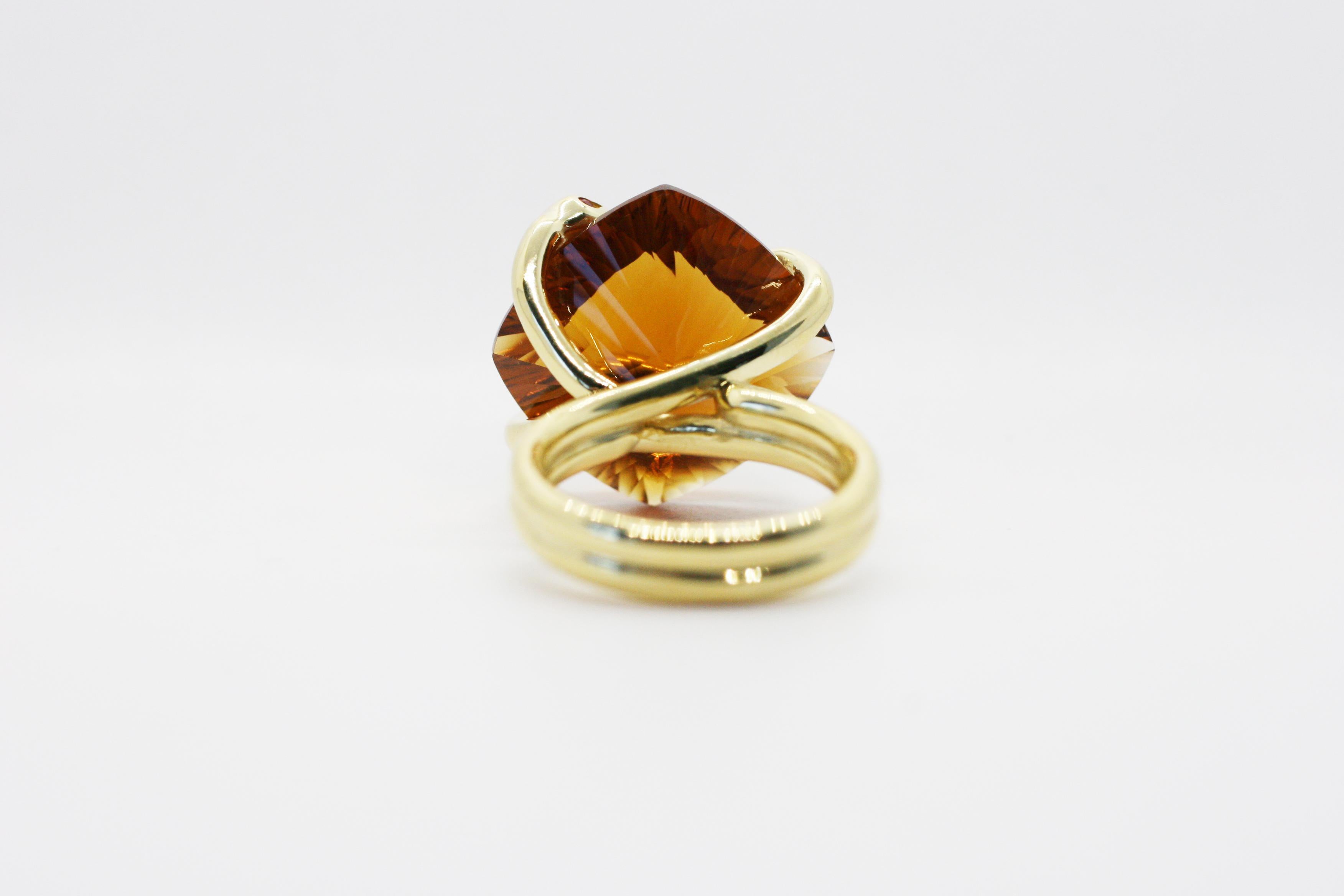 18k Yellow Gold Citrine Climbing Snake Ring features Perez Bitan's signature curved snake with ruby eyes that wraps around the finger and sets the custom cut natural citrine in place. 
Citrine has concave facets on the underside.
18k Yellow Gold,