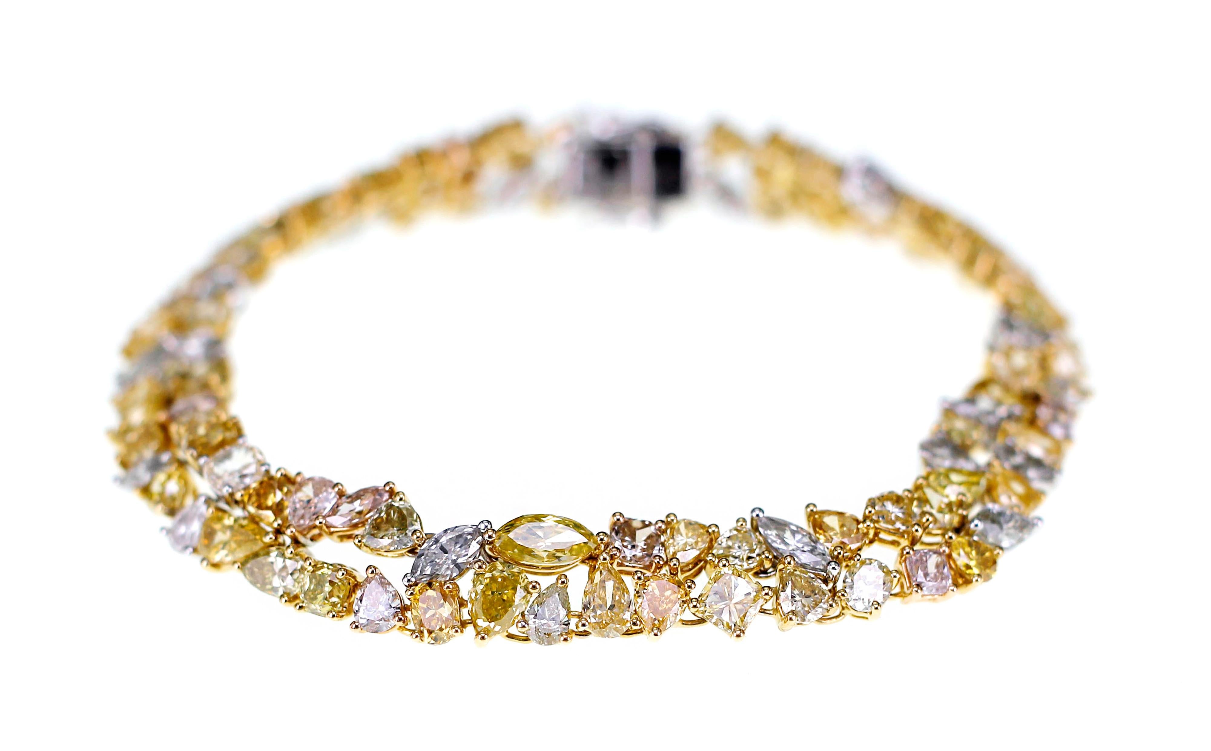 A total of 15.71 carat of natural fancy color diamonds are studded in this one of a kind bracelet. All the pieces of diamonds are individually set on the bracelet by hand. This hand made bracelet settles on your hand as if its made on custom order. 