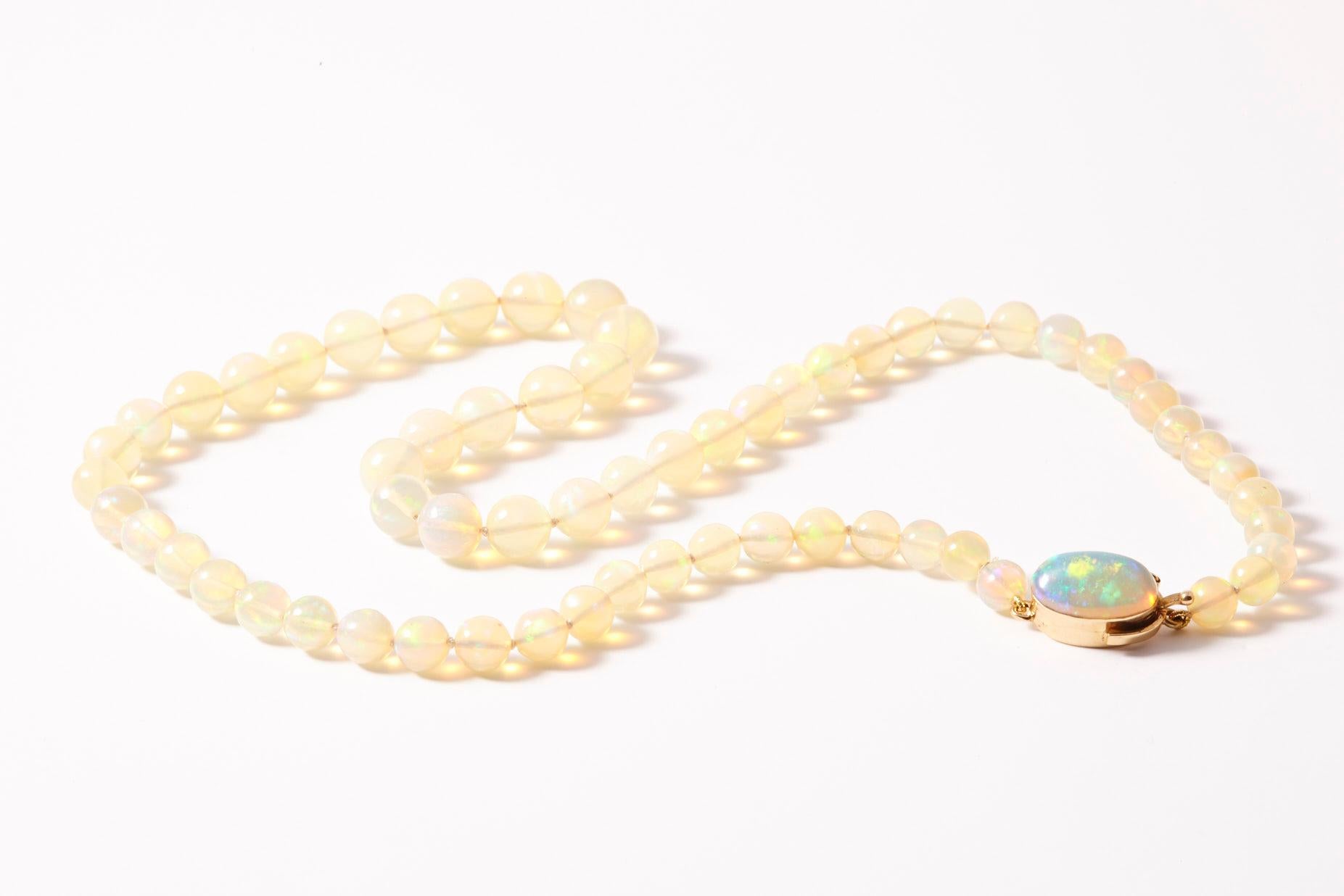 Vintage Jelly opal graduated bead necklace generations with matched cabochon clasp. This one of a kind vintage find is an estate piece with classical sensibilities. Individually knotted by hand with a silk cord and 18K clasp set with a matching