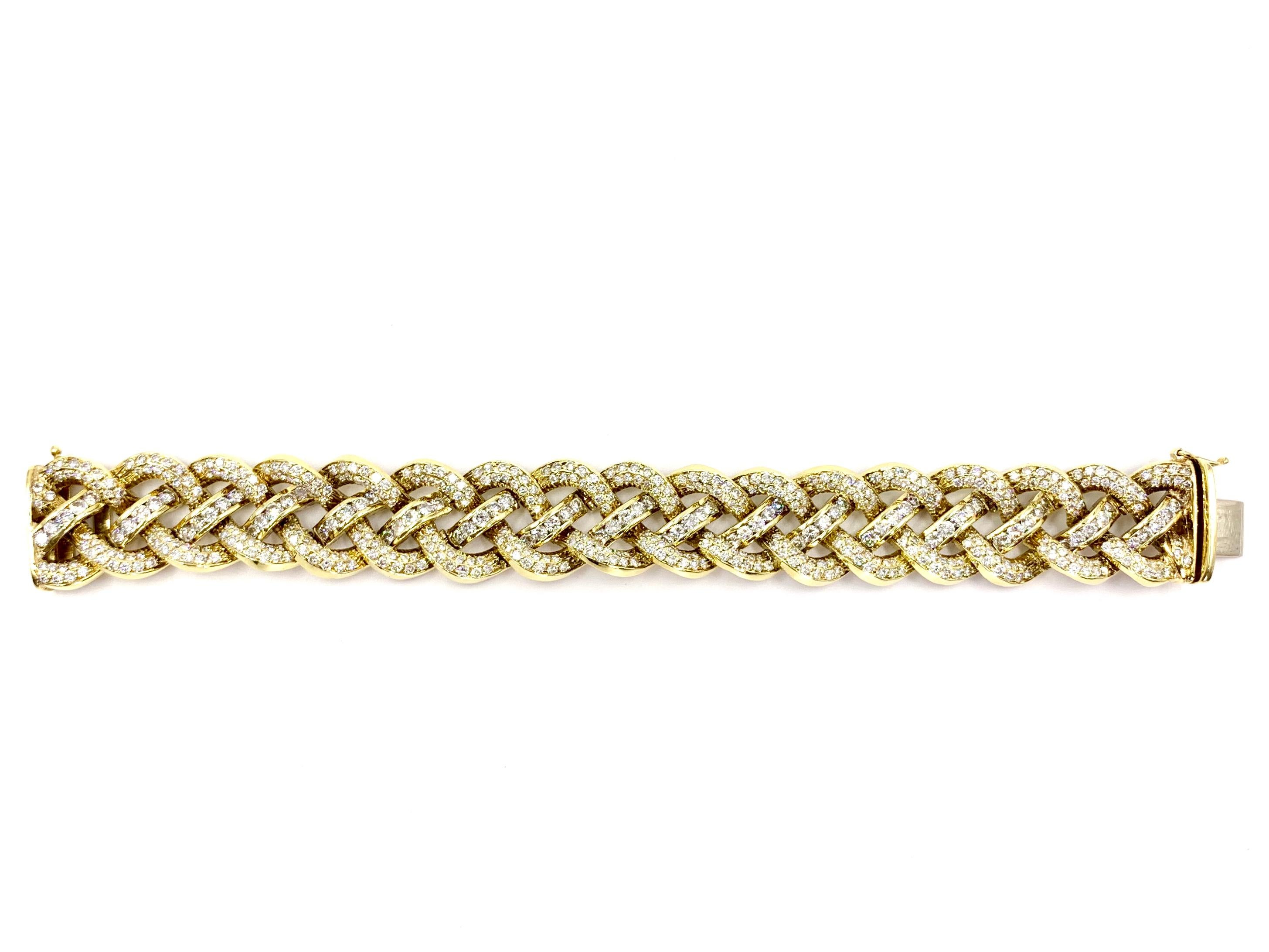 18 karat yellow gold open woven diamond bracelet featuring 12.60 carats of round brilliant diamonds. Diamonds are approximately F color, VS2 clarity. Bracelet gives the illusion that four strands weave perfectly together while individual links go