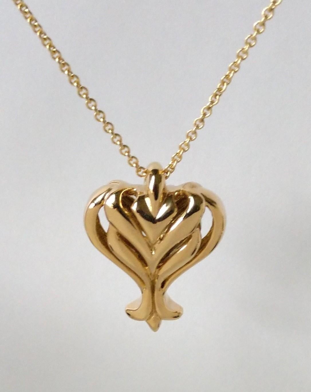 18 Karat Open Pierced Heart Pendant Necklace for women. Hand sculpted by Tiffany designer Thomas Kurilla. This is a double sided open pierced heart. Hand sculpted. Not done in CAD. 1 3/8 h x 1 inch wide X 7/16ths deep. It is a substantial size