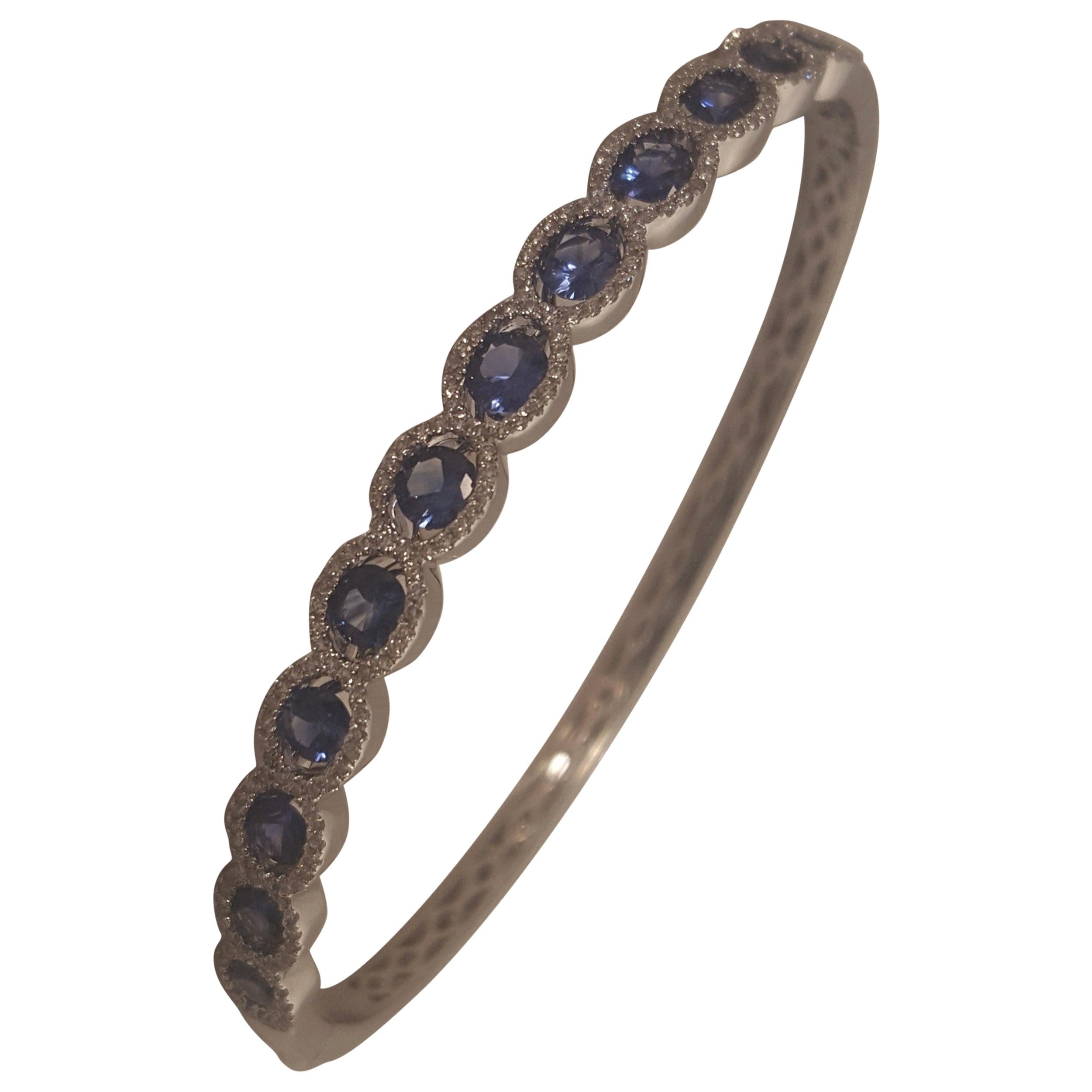 18 Karat Oval Sapphires and Diamonds Bangle Bracelet For Sale