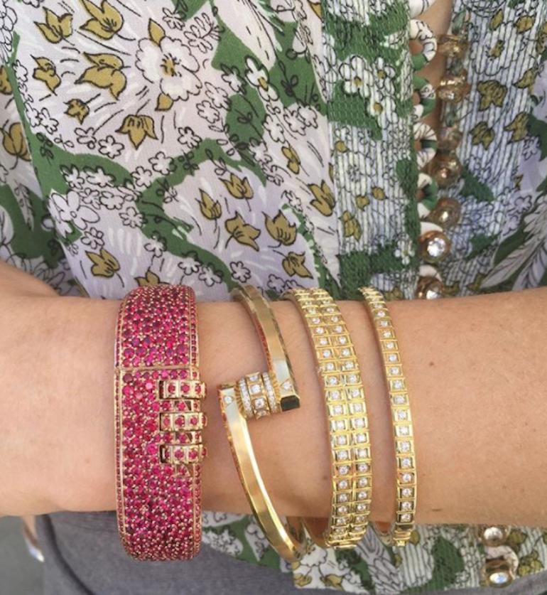 18 Karat Pave Ruby Code Bracelet features a solid 18k Rose Gold bracelet with full pave rubies and a custom code that opens and locks the bracelet onto the wearer's wrist. 
Lock Combination can be customized with any variation of 3 symbols, letters,