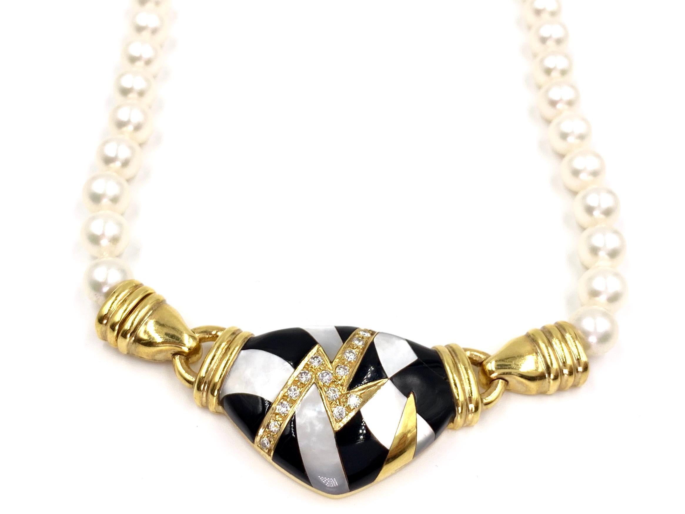Created by Asch Grossbardt, a strand of beautiful white cultured pearls are fixed with an 18 karat yellow gold modern designed center pendant adorned with white diamonds, white mother of pearl and black onyx inlay. 15 round diamonds have a total
