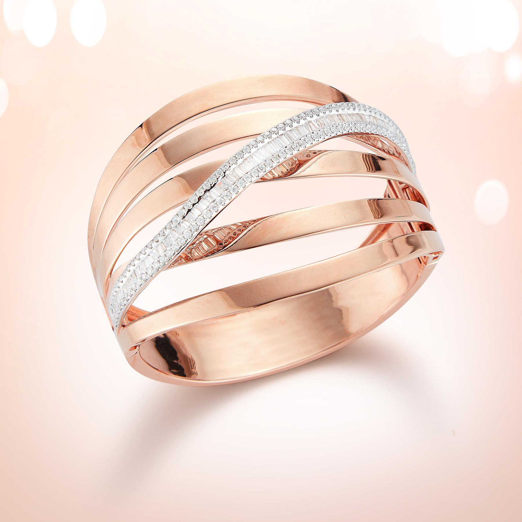 Gorgeous Eye-Catching 18K Pink Gold Bangle Bracelet in a unique Cuff-Style with 5 Winding Rows of Smooth Pink Gold Intertwined with a Winding Row of Round & Baguette Dazzling White Diamonds totaling 3.64 carats.