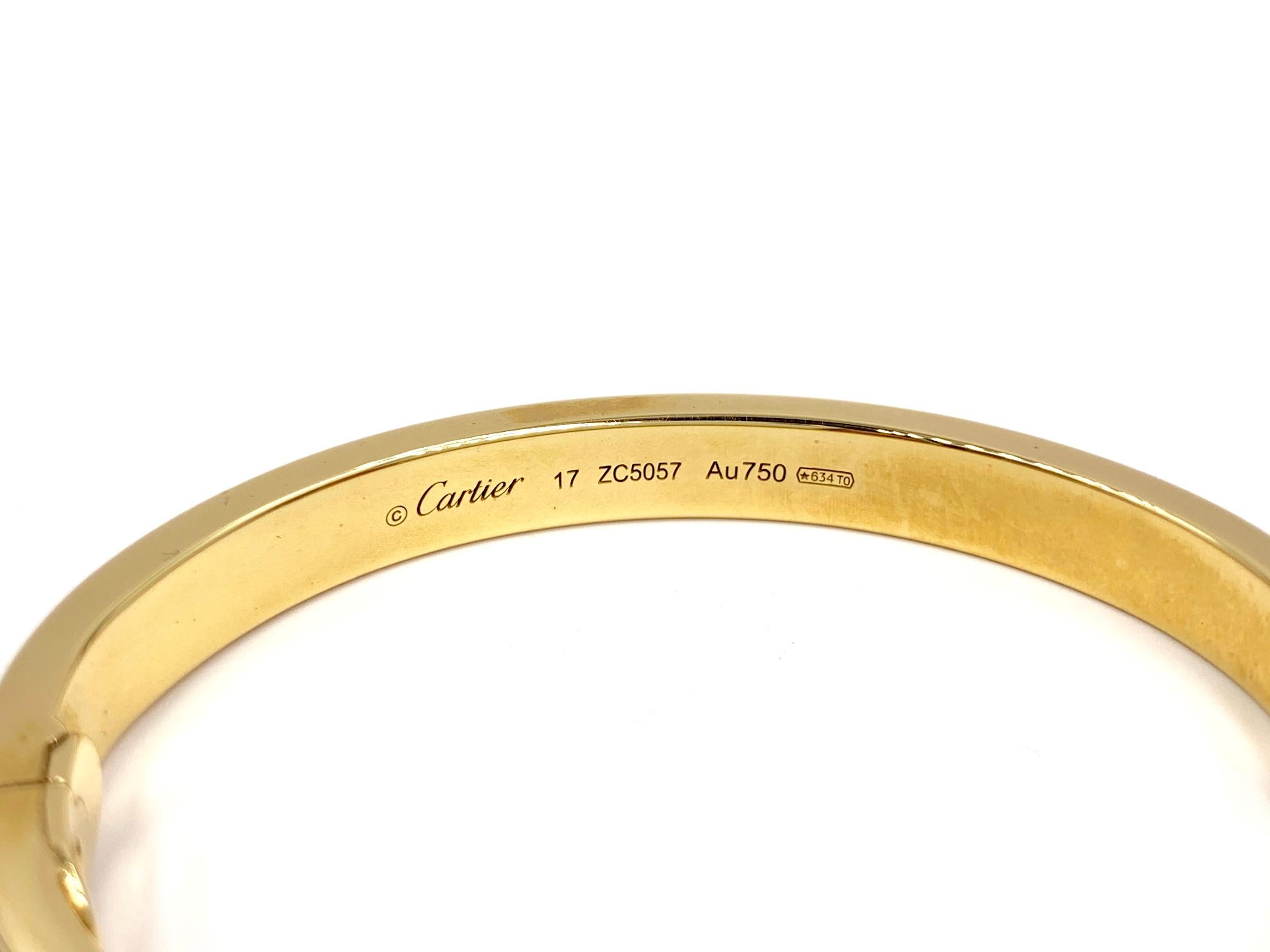 The iconic authentic Cartier LOVE bracelet made in 18 karat yellow gold with 204 brilliant-cut diamonds weighing 2.00 carats. Timeless design has a soft oval shape with gold nail heads. This bracelet is hinged and features a safety latch and push
