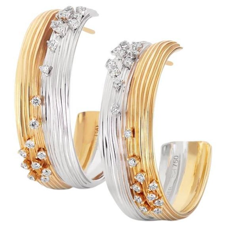 18k (750) gold debris: two white gold earring clasps, ye…