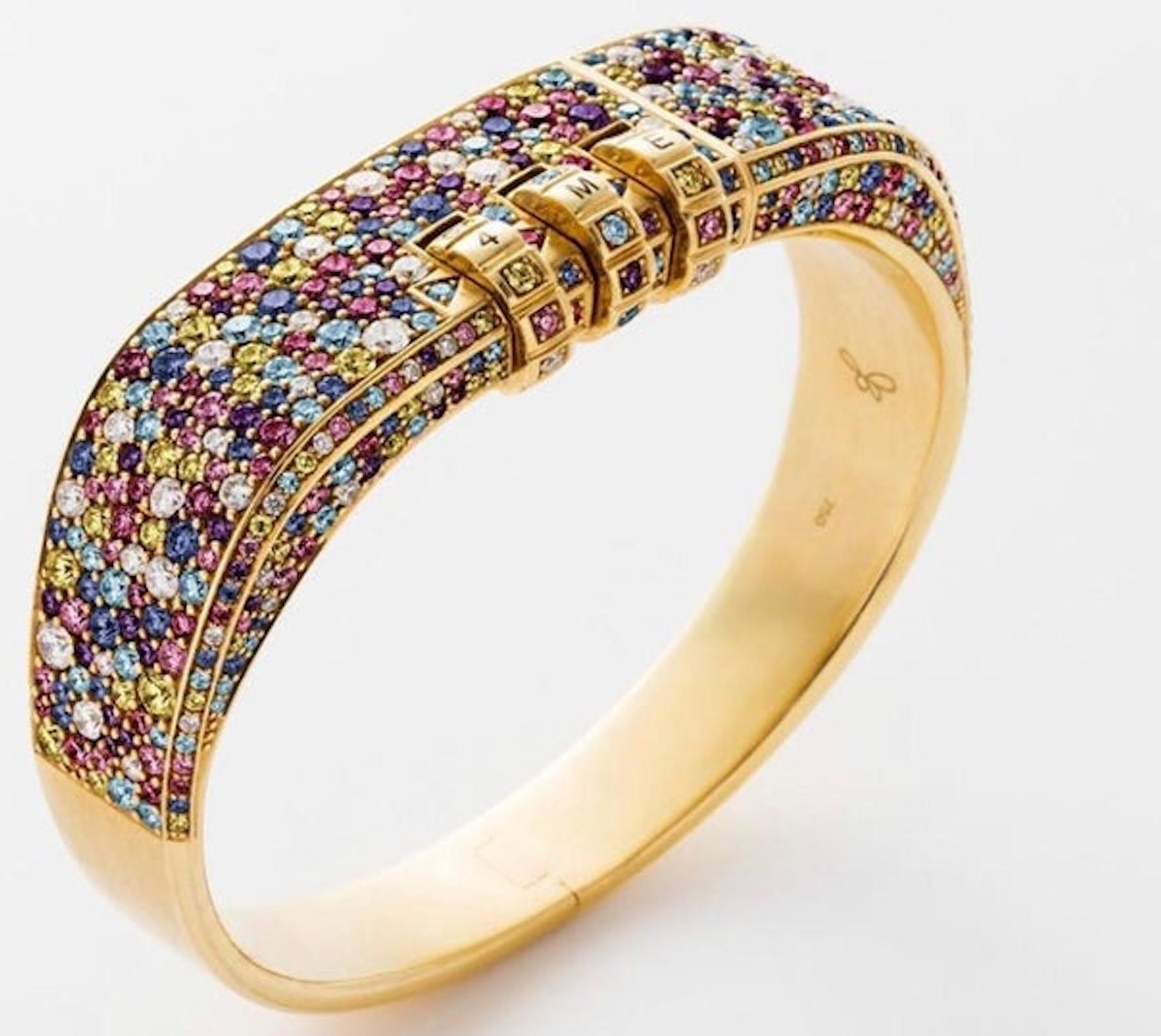 18 Karat Pave Code Bracelet features a solid 18k Yellow Gold bracelet with pave White Diamonds, Aquamarines, Pink Sapphires, Yellow Sapphires, Blue Sapphires, and Amethyst, and a custom code that opens and locks the bracelet onto the wearer's wrist.