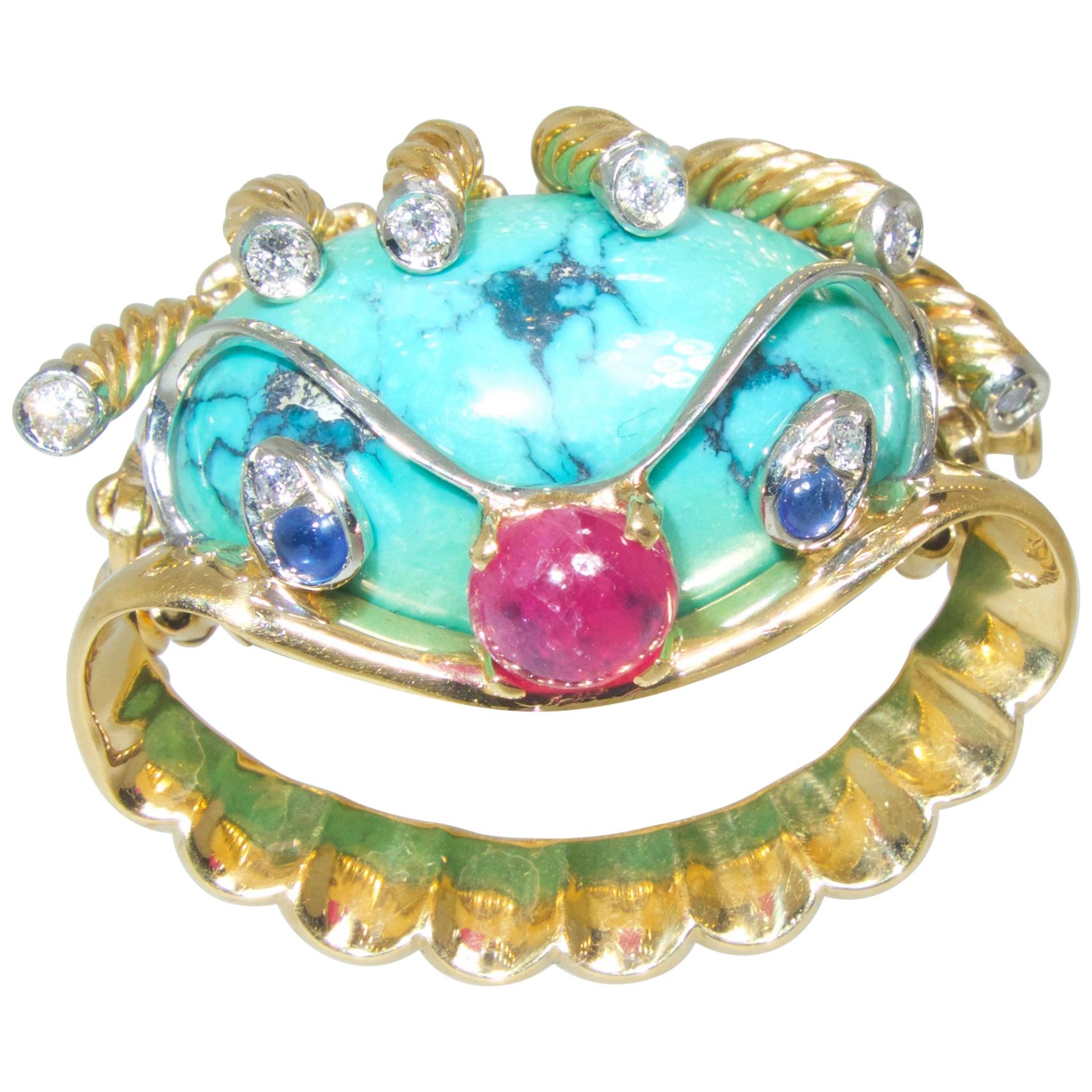 18K brooch centering natural blue turquoise, natural sapphires and ruby.  This whimsical clown motif brooch with 