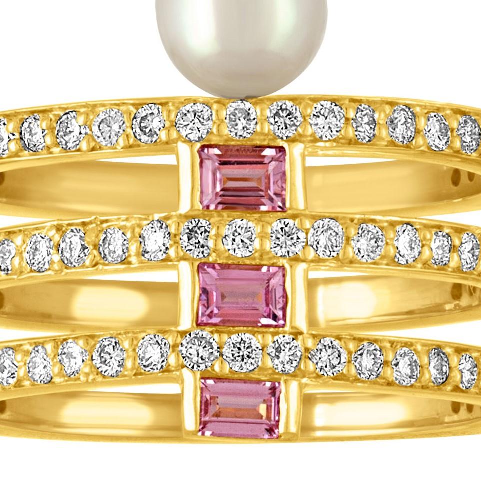 A bold and modern piece, this 18 Karat gold ring combines a mix of diamonds with pink sapphire baguettes.  Edging the ring is a chunky white pearl 
Materials: 18 Karat Gold, 1mm Diamonds (1.00ct), 3 x 2mm pink Sapphire Baguettes, 5mm white Akoya