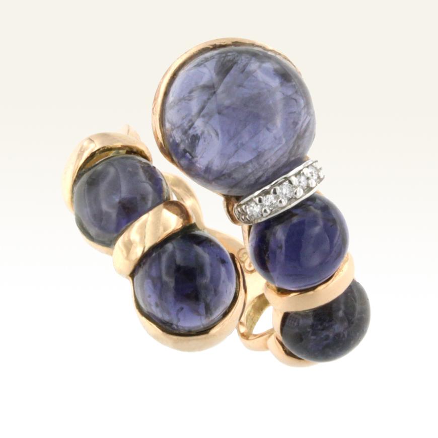 Ring in rose and white gold with Iolite in round cabochon cut (size: 12 and 8 mm) and White Diamond ct 0.06  VS colour G/H. 
Legend says that sailors used a Iolite lens, with which they could define the exact position of the Sun, moving easily