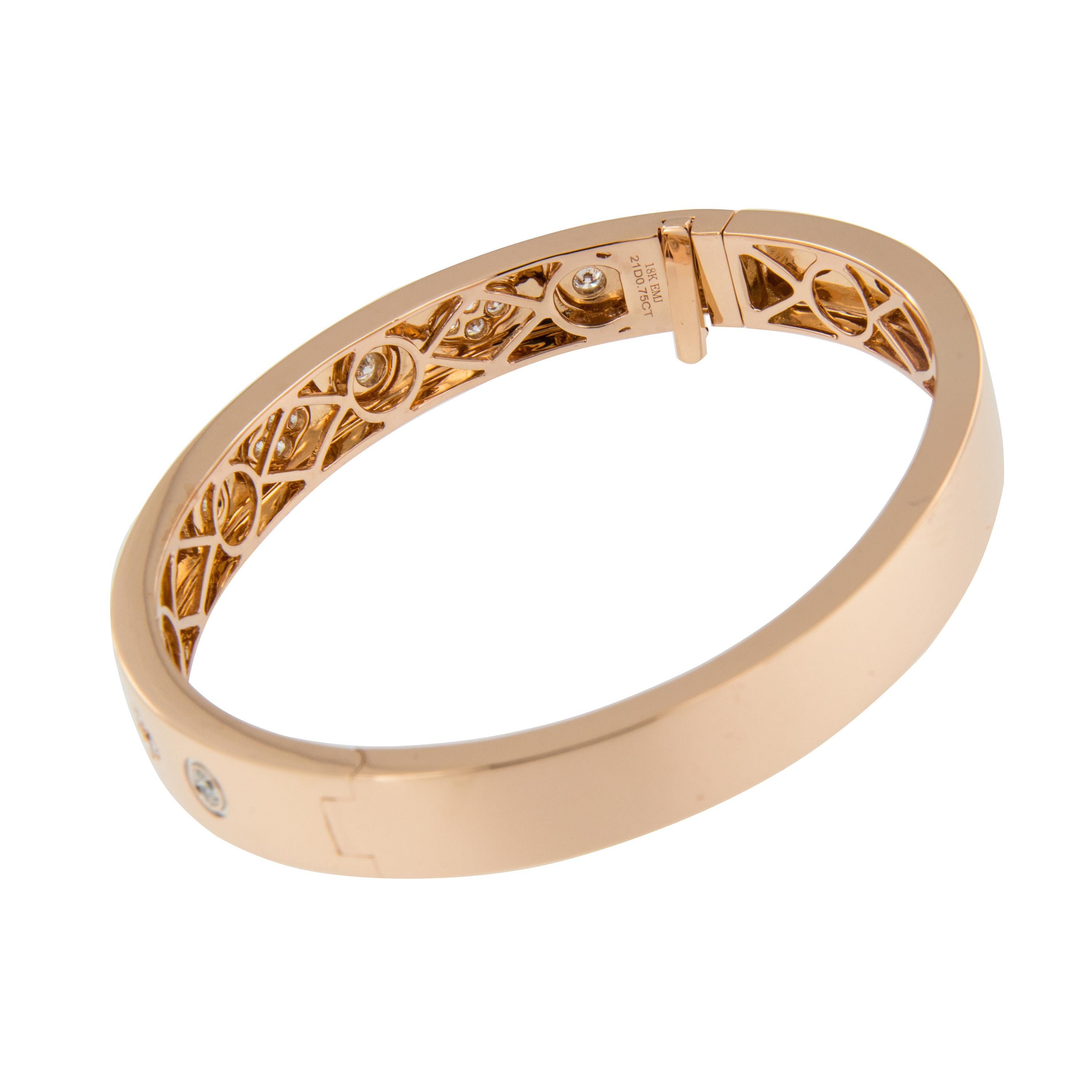 Beautifully hued 18 karat rose gold bangle bracelet is perfectly accented with 0.75 Cttw VS clarity, F-G color diamonds in clover pattern expertly burnished set for a smooth look and feel.  Bracelet is hinged for ease of putting on & taking off