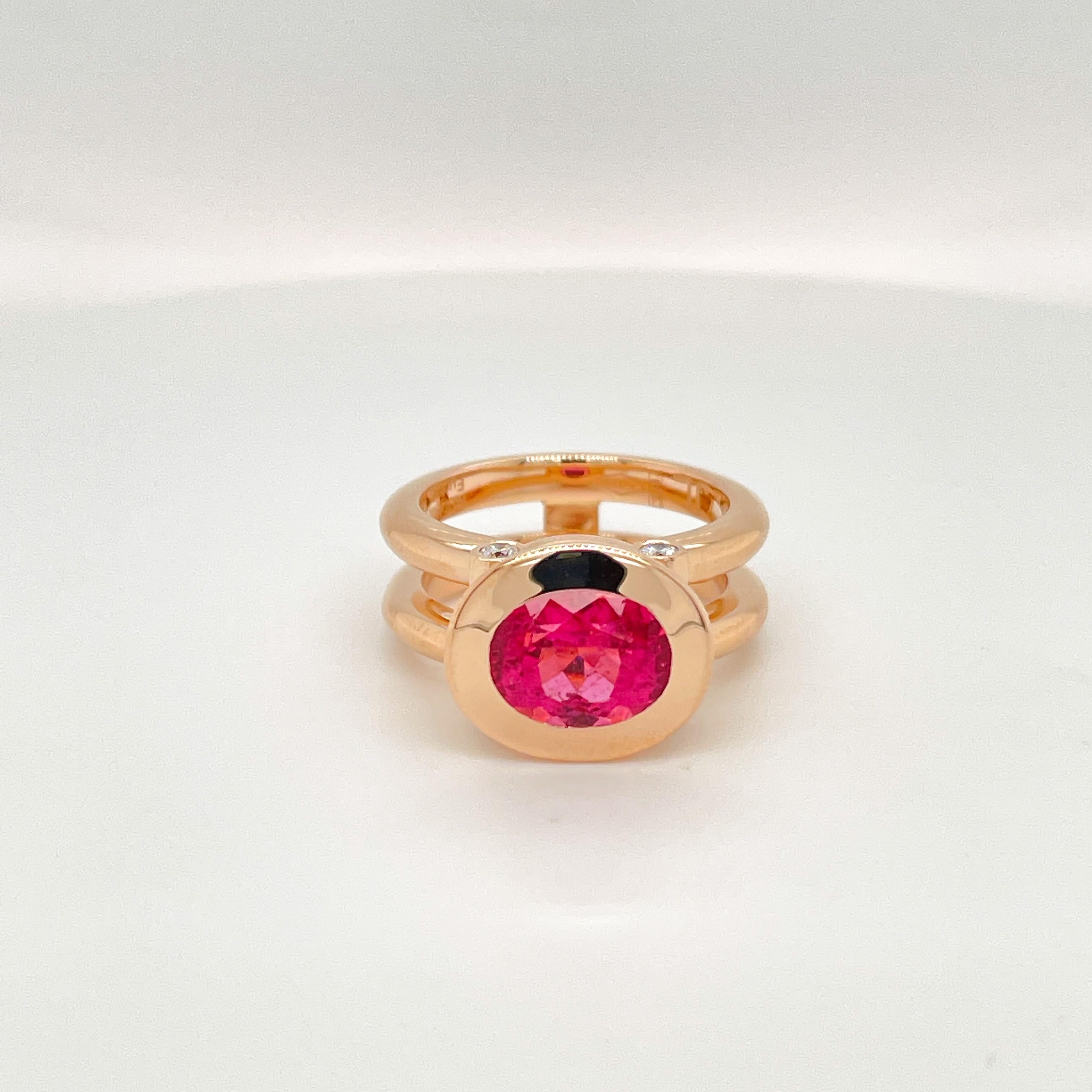 18 Karat Rose Gold Cocktail Ring featuring a 3.8 Carat bright Fuchsia Rubellite stone.

Oval cut measuring 9.8x 8.5mm.
The Fuchsia Rubellite is supported by 4 VS1 G diamonds weighing 0,20 ct.

This design is one of Jochen Leen's first designs and is