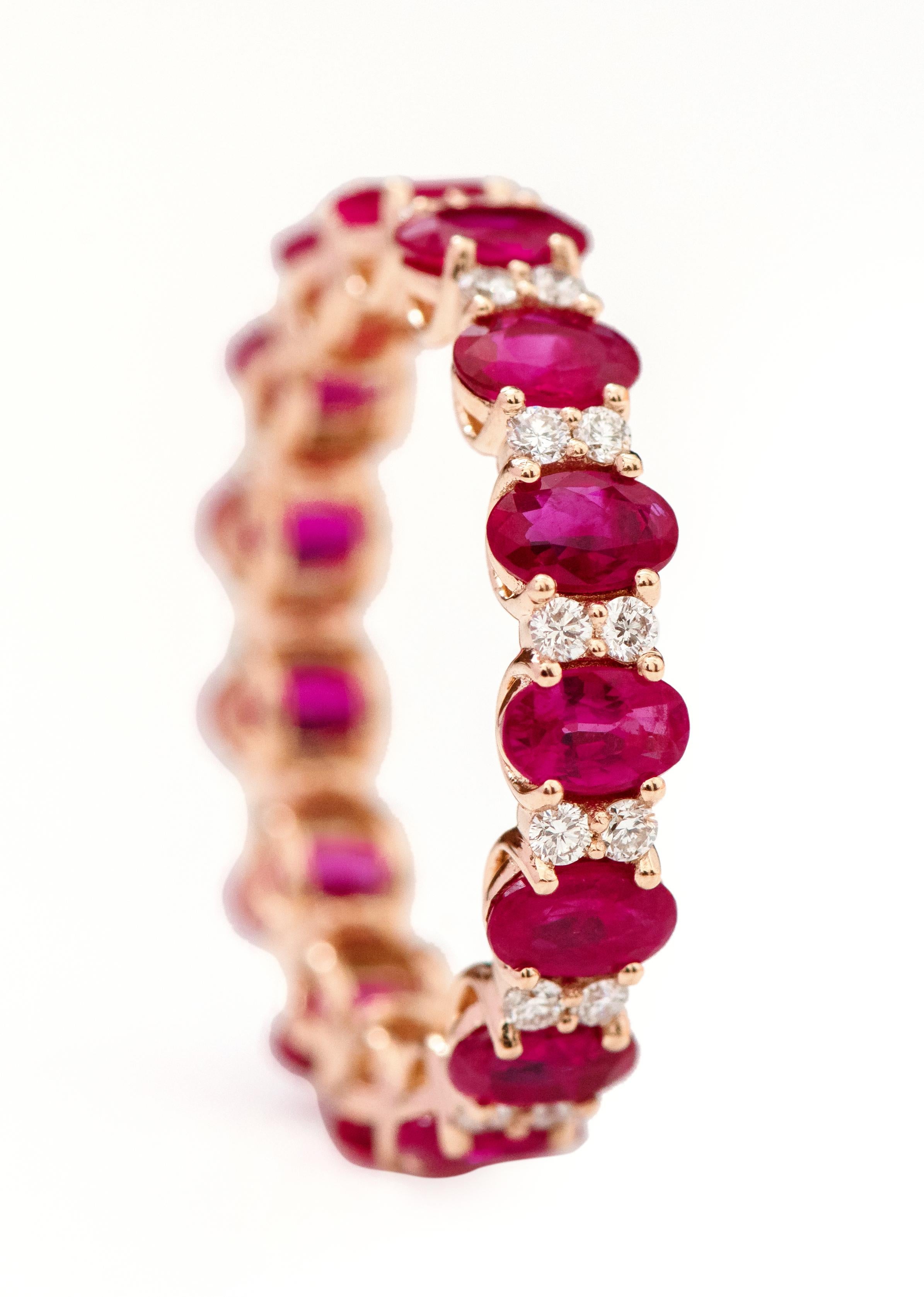 18 Karat Rose Gold 4.00 Carat Oval-Cut Ruby and Diamond Eternity Band Ring

This enchanting vivid red ruby and diamond band is magnificent. The solitaire horizontally placed oval shape ruby in grain prong setting is complemented with two round