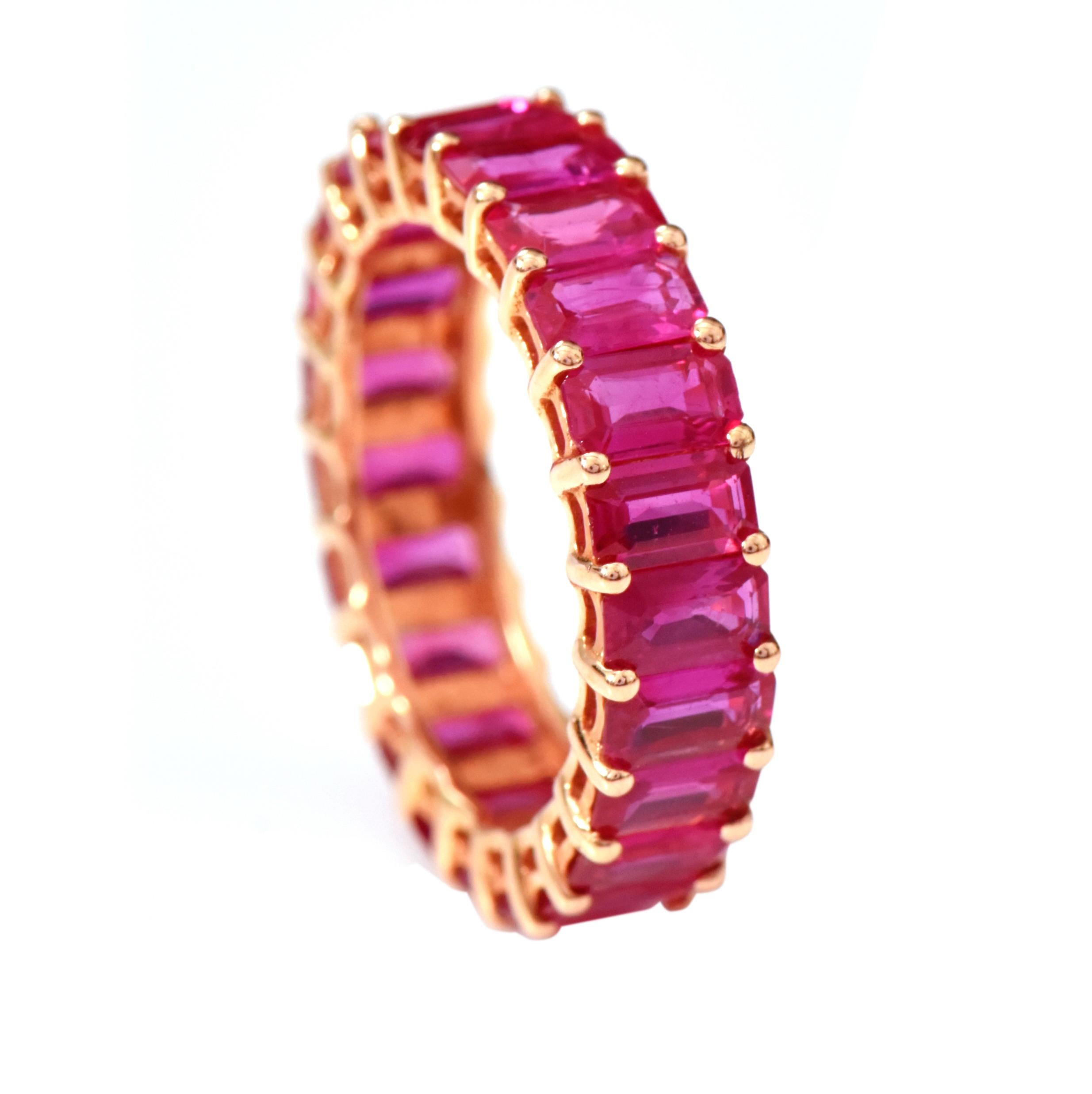 18 Karat Rose Gold 5.63 Carat Ruby Emerald-Cut Full Band Ring 

This exquisite crimson red emerald-cut ruby full band is tasteful. The identically matched and sized 22-emerald cut rubies are strongly held by the common prongs in the grain setting.