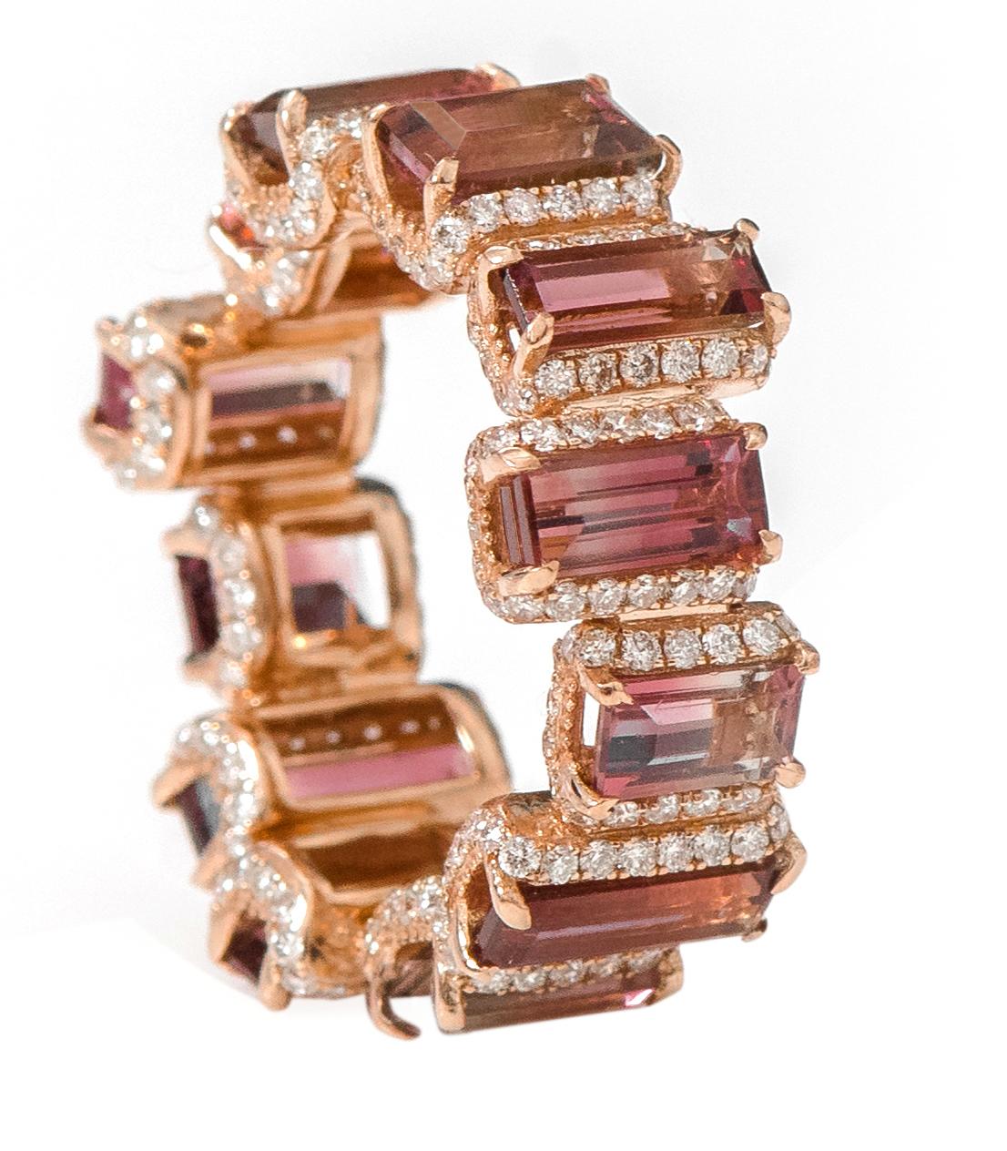 18 Karat Rose Gold 7.79 Carat Baguette-Cut Tourmaline and Diamond Eternity Band Ring

This dynamic fantasy rose pink-purple parti-color tourmaline and diamond band is incredulous. The solitaire horizontally placed baguette-emerald cut tourmaline in