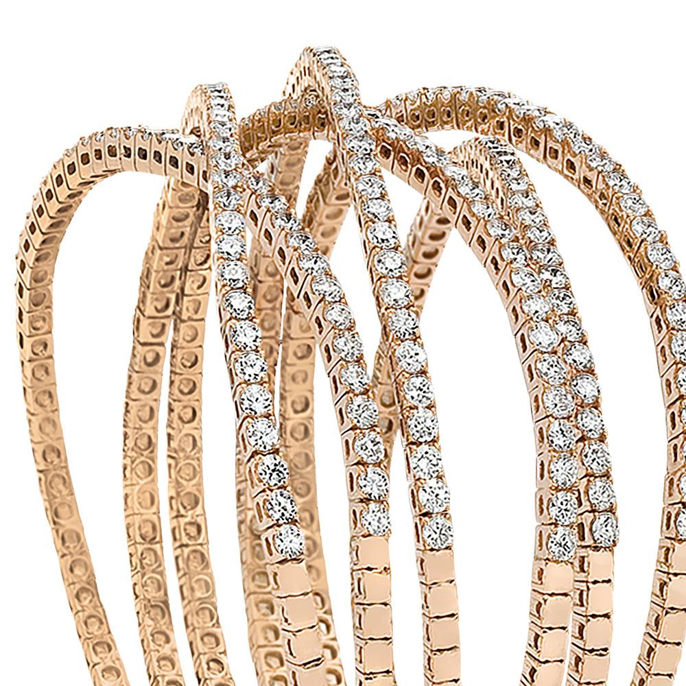 This stunning flexible cuff is set in 18 karat rose gold, with 8.72 carats of round brilliant diamonds. The Diamonds are set in six flexible rows which span three quarters around the wrist, making this bracelet an easy to wear staple. The oval shape