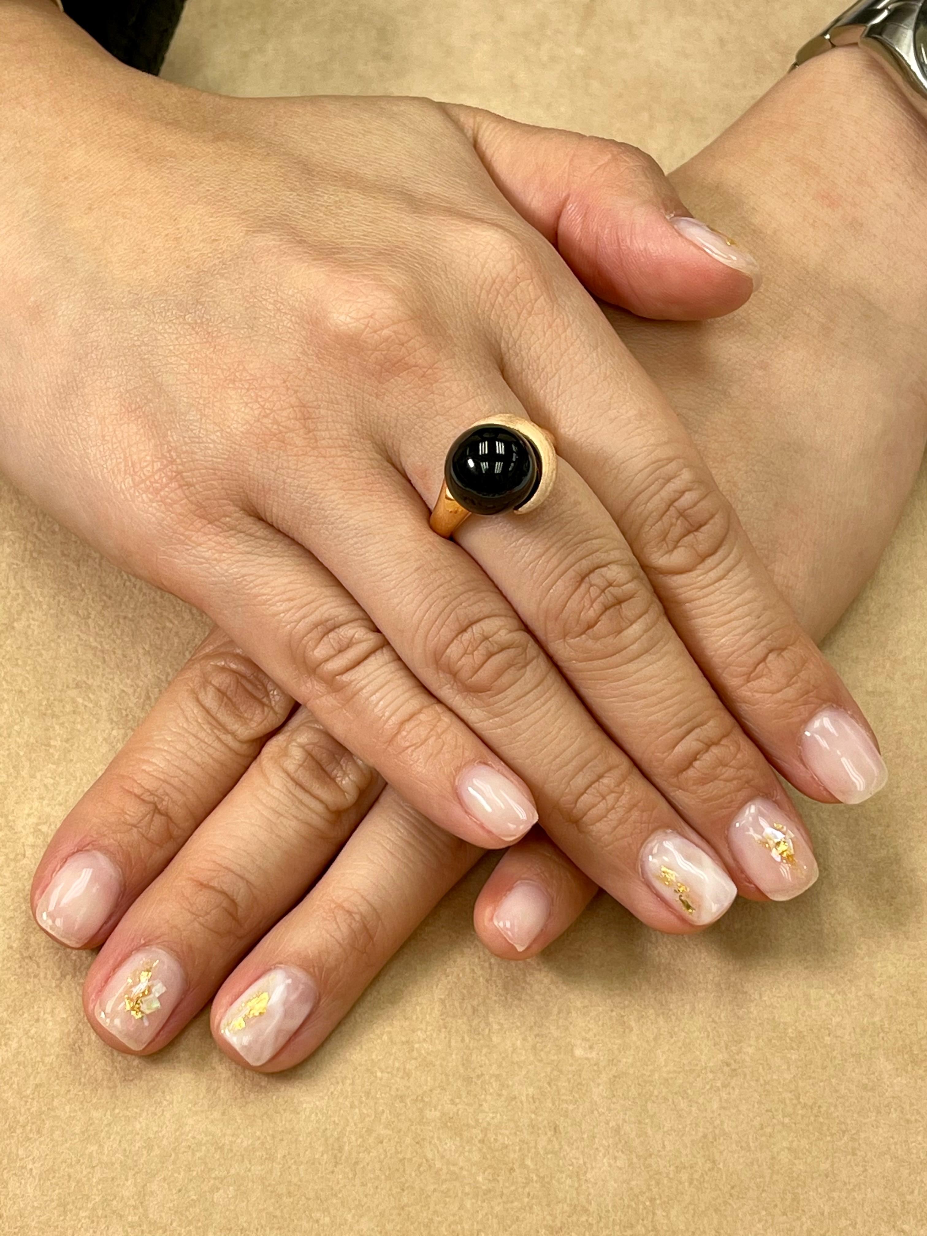 Here is a beautiful Onyx ring. It may look simple but the fact is that it is very very difficult to make because of the curve lines. The ring is set in 18k rose gold. The Onyx is 12mm in size and round. The combination of black and rose gold color