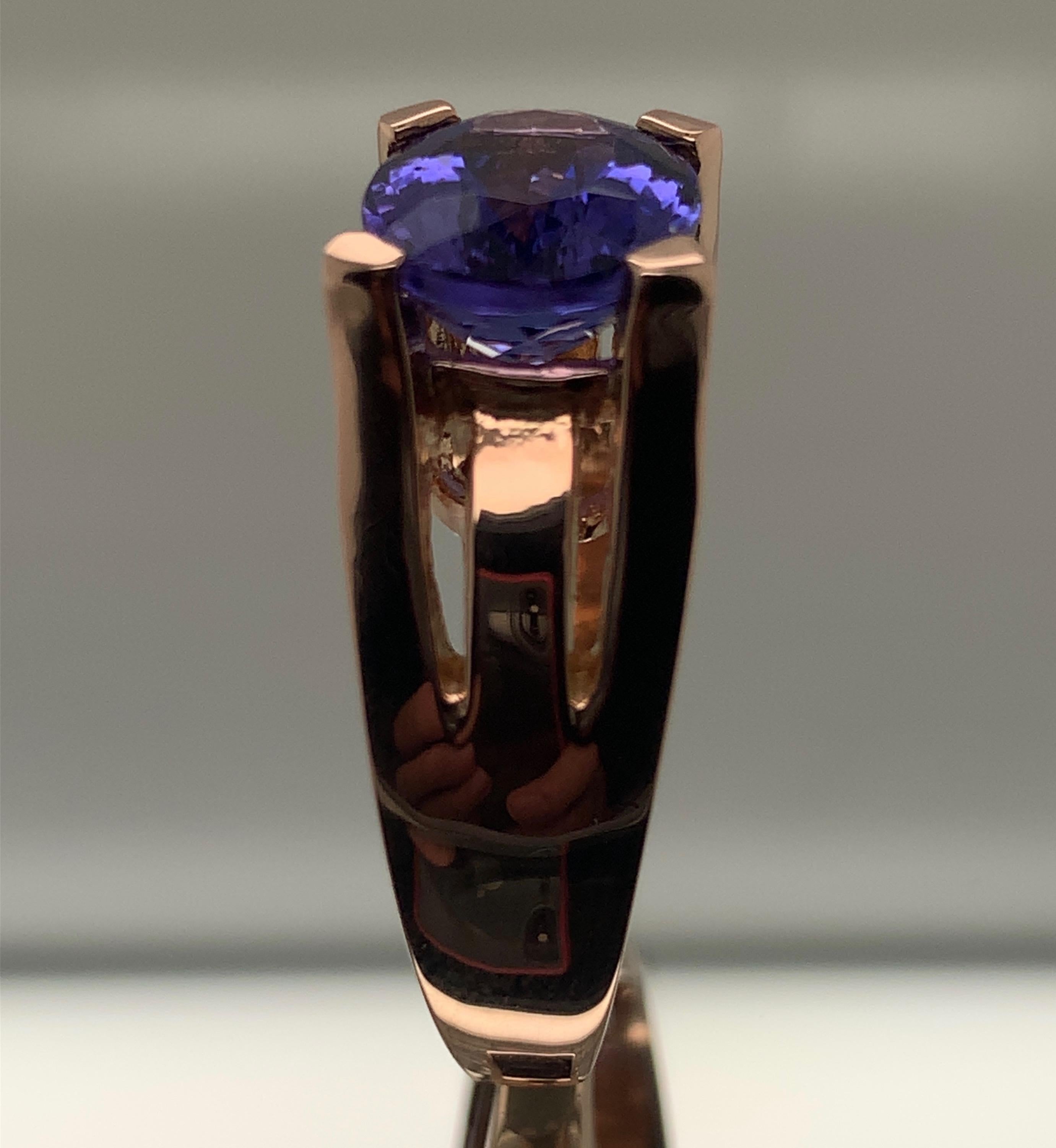 Tanzanite set in rose gold is one of our favorite things to do. 
This Tanzanite weighs 3.94 carats and is the characteristic blue / purple color of a typical Tanzanite. 
The ring is custom made  in 18-karat heavy rose gold. The ring is a size 6 3/4