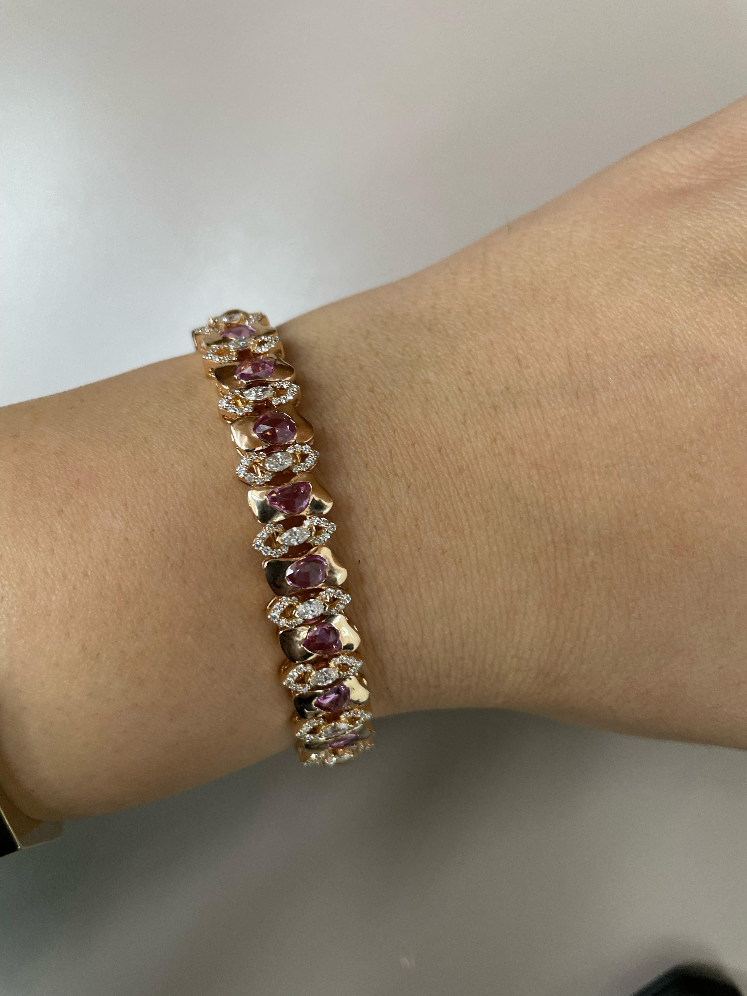 Charming and magnificent, this simple, yet highly exclusive Pink sapphire Arabesque Bangle captures the essence of true luxury. Remarkably crafted with Pink sapphires stones surrounded by a medley of fine diamonds. The Pink sapphire with white